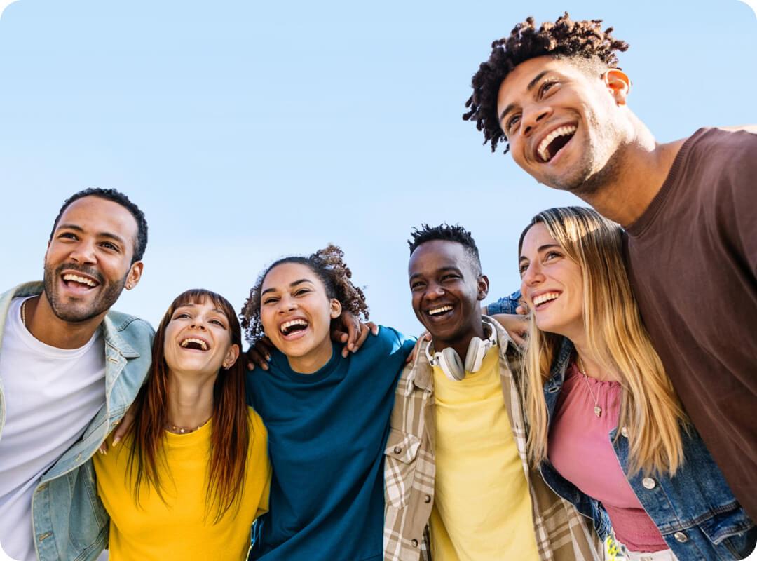 A group of young men and women smiling together.