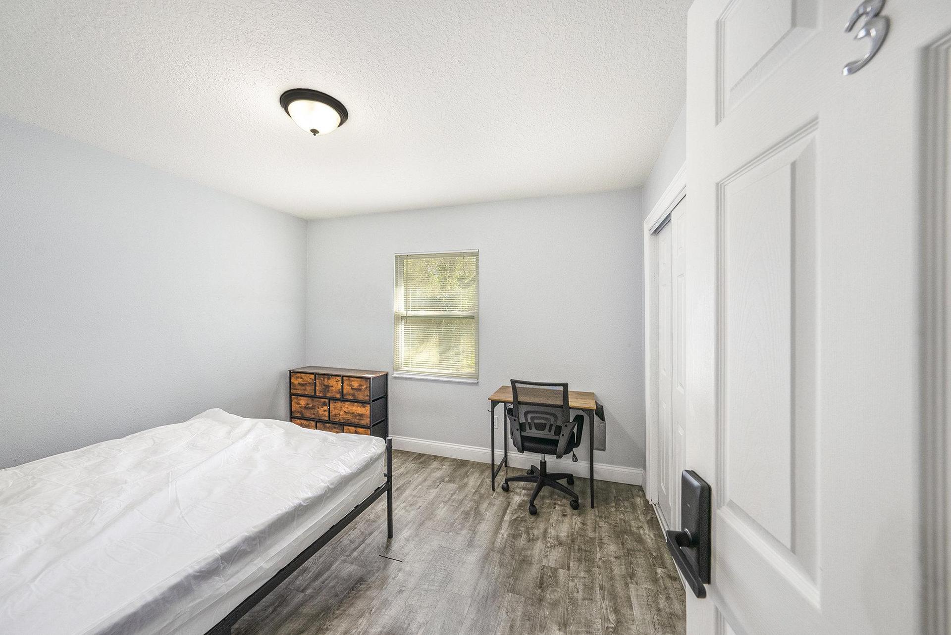 Spacious Room with a closet and desk.