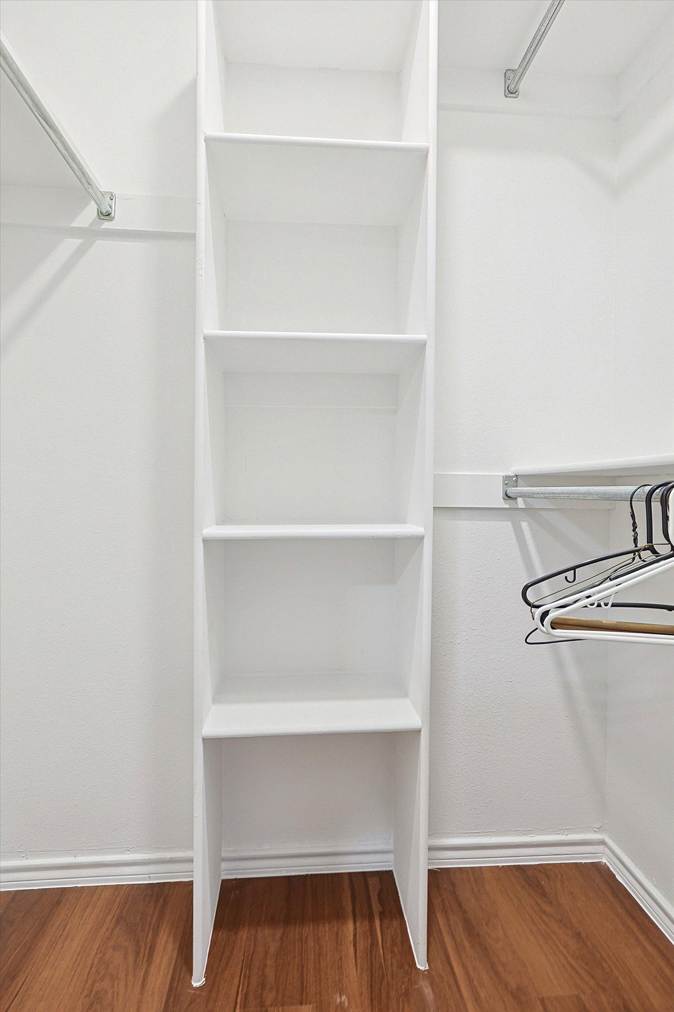 walk in closet with extra shelf storage