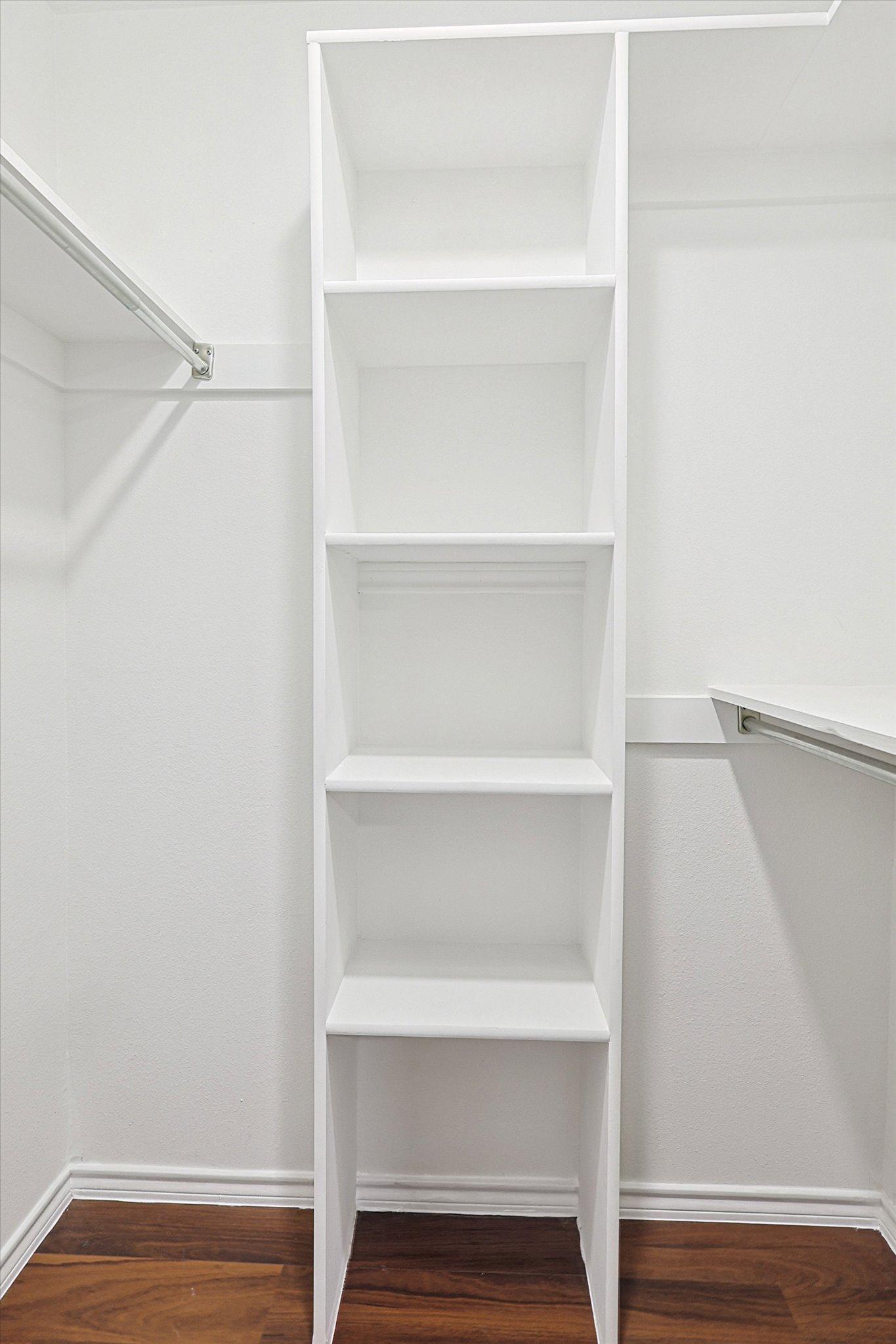 Walk in closet with shelf storage