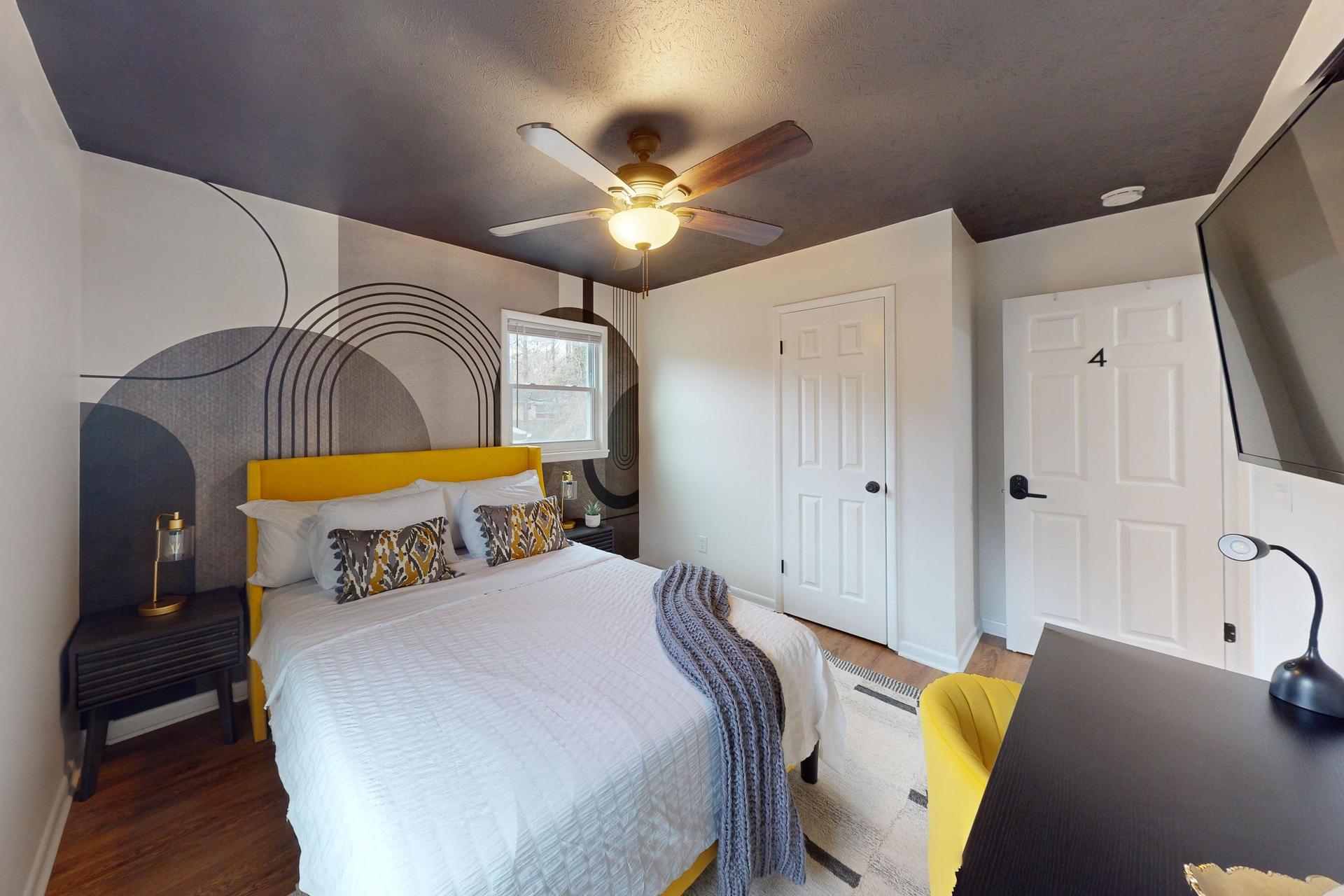 Queen Bedroom  with a desk and a TV