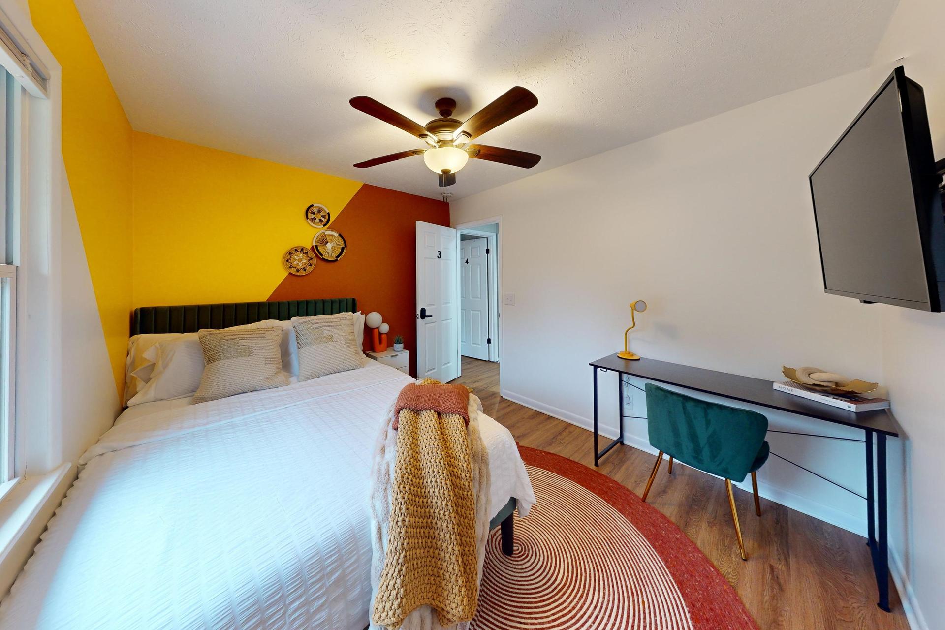 Queen Bedroom  with a desk and a TV