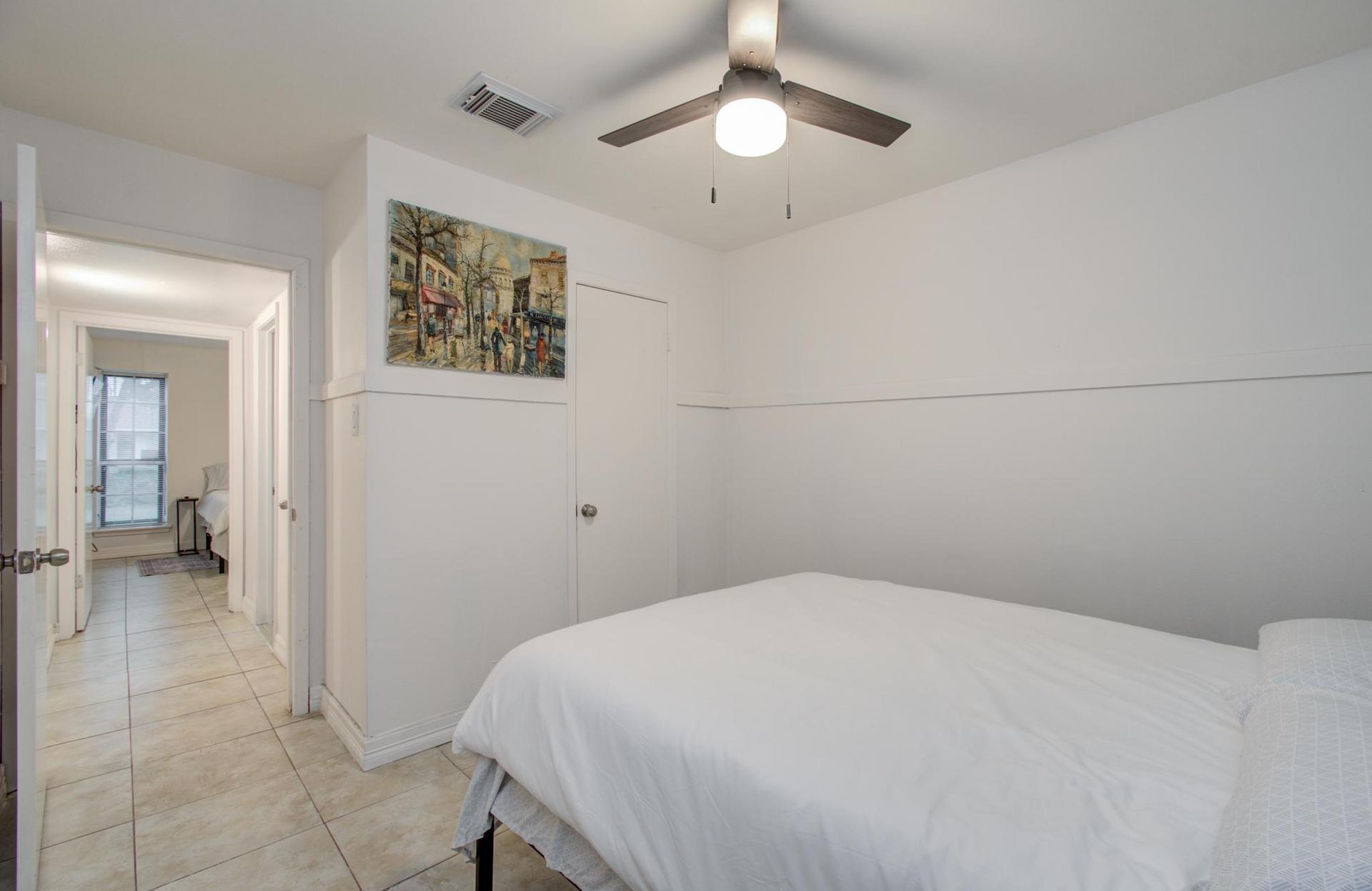 Bedroom with closet, next to bathroom and laundry room. Faces the backyard.