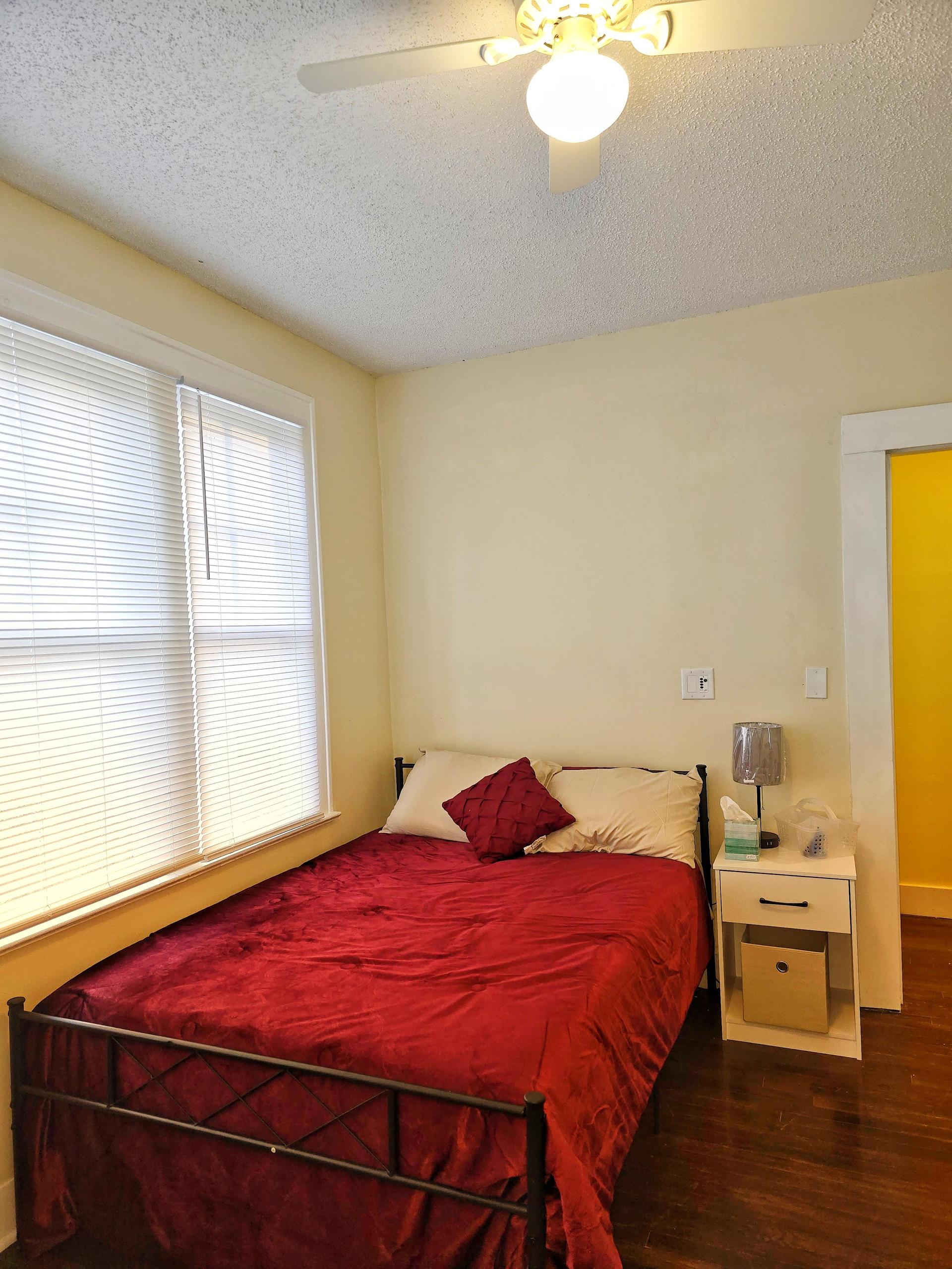 Room 2 is a corner room equipped with a full bed, linens, TV, mini fridge, desk, chair, nightstand, clothing rack,  dresser!