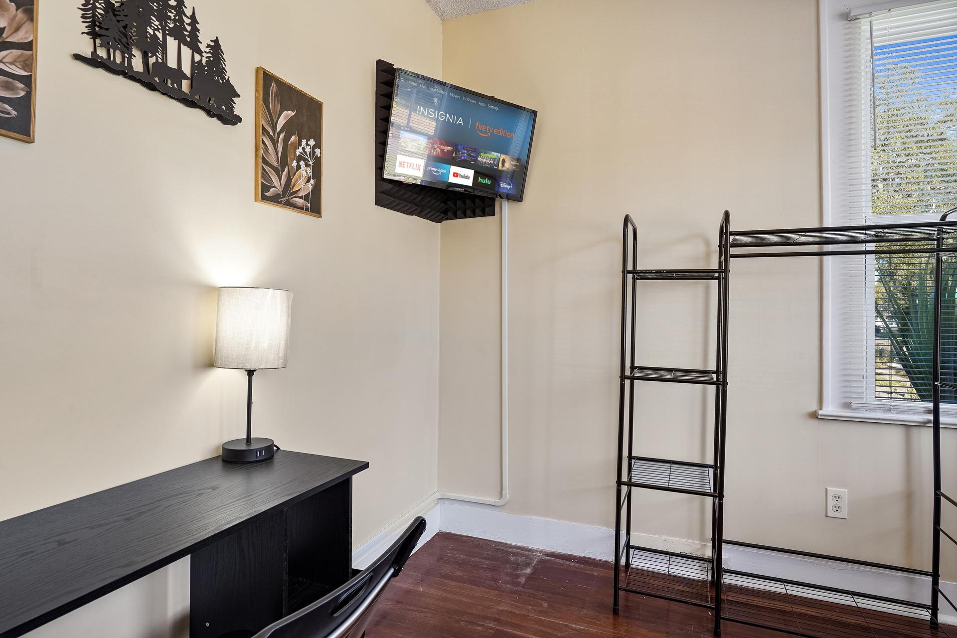 Room 2 is a corner room equipped with a full bed, linens, TV, mini fridge, desk, chair, nightstand, clothing rack,  dresser!