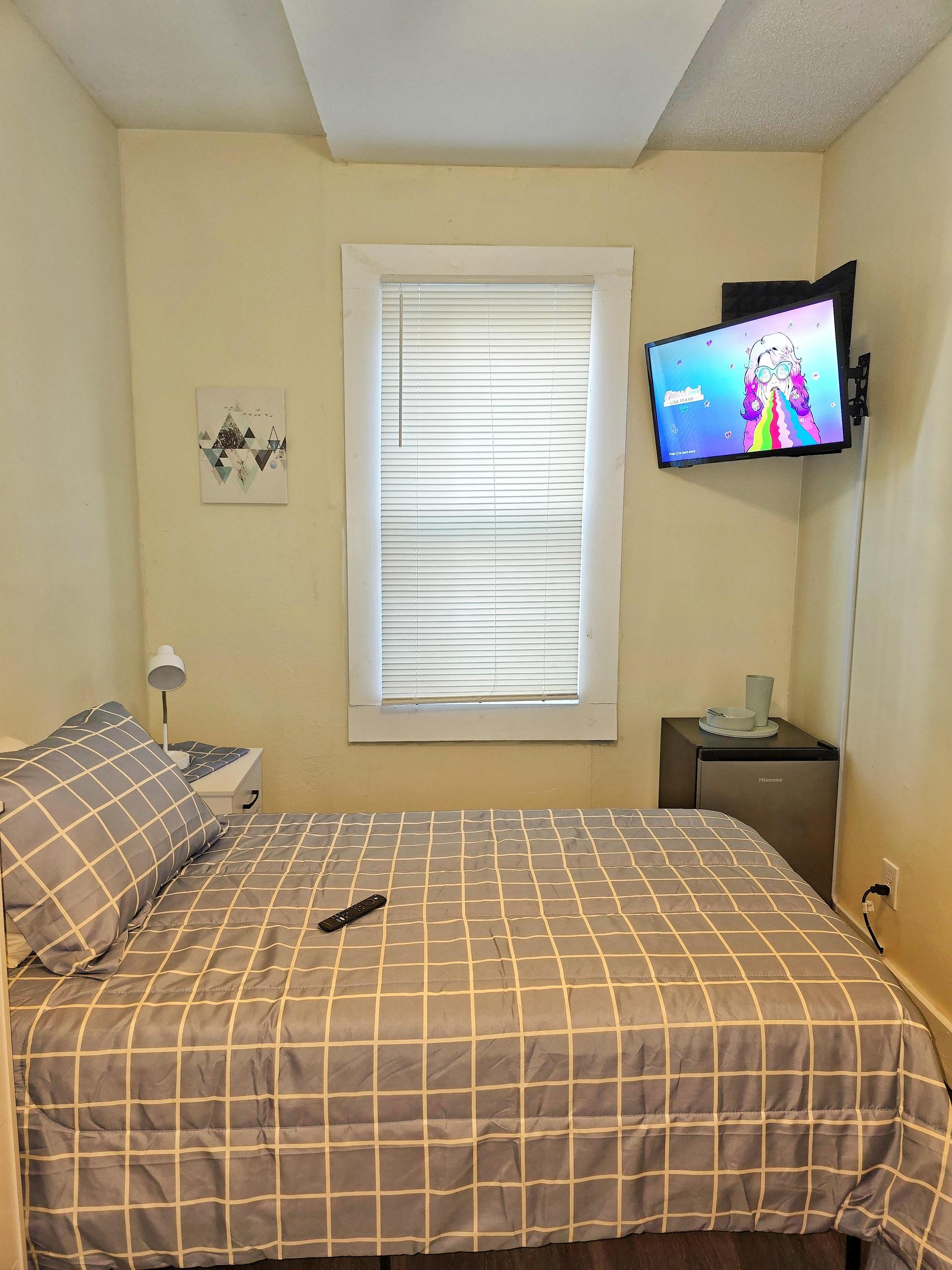 Room 6 comes with full bed, linens, TV, mini fridge, desk, chair, nightstand, clothing rack,  dresser