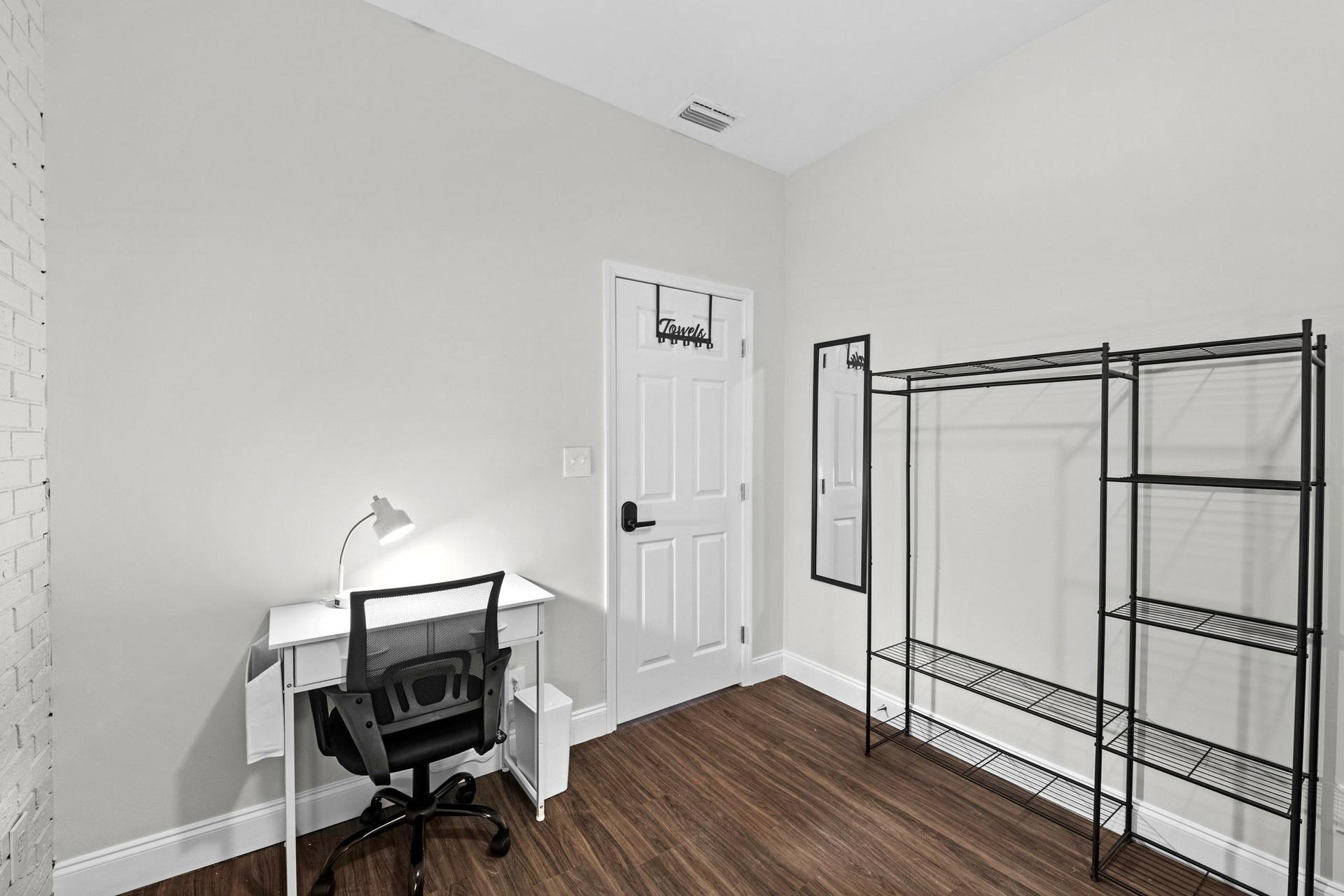 Desk with lamp & office chair.  Clothing rack, towel bar & mirror and private entrance, plus ceiling fan