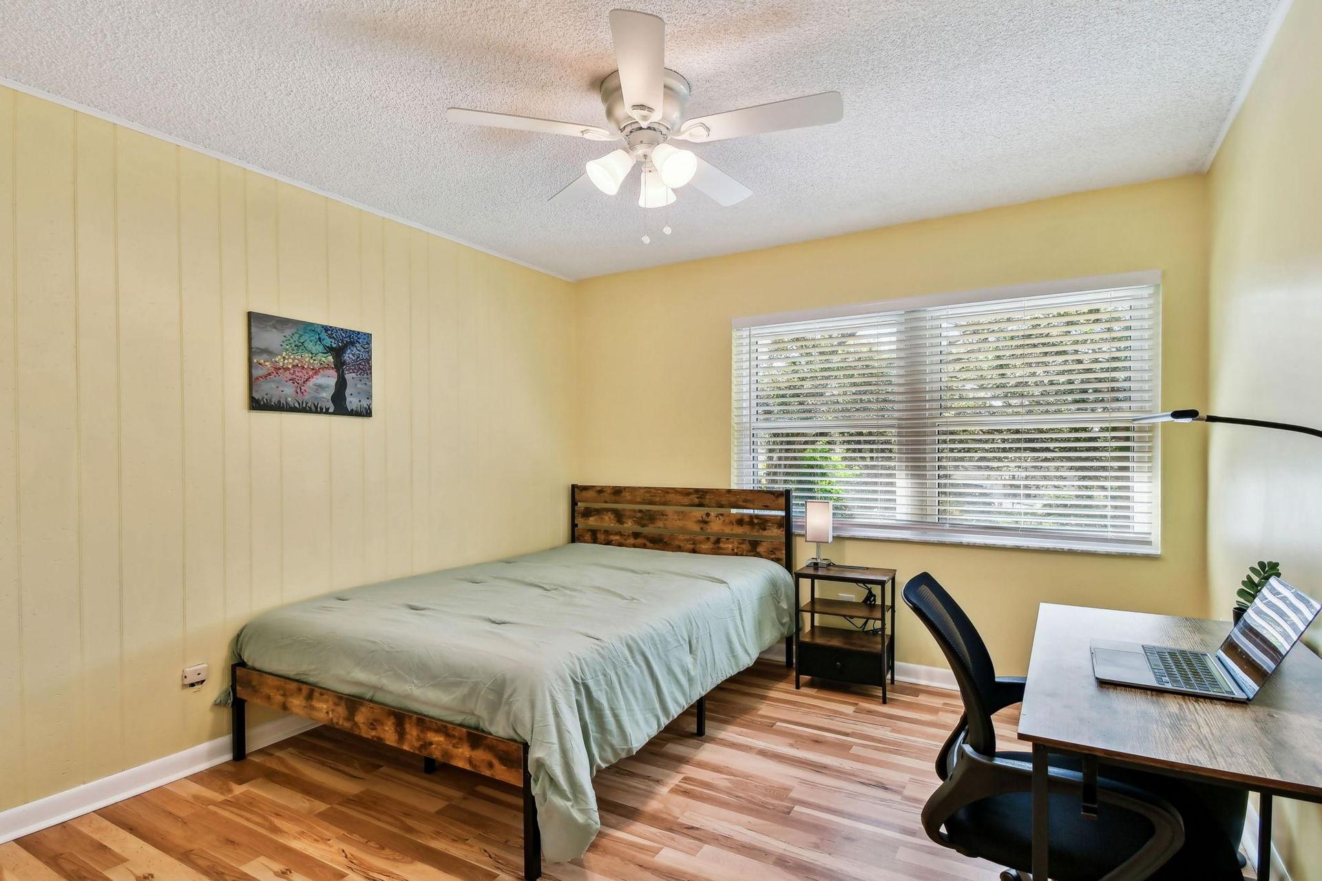 Full size cozy full size bed, with end table, light, desk, office chair and light, storage container under the bed and closet