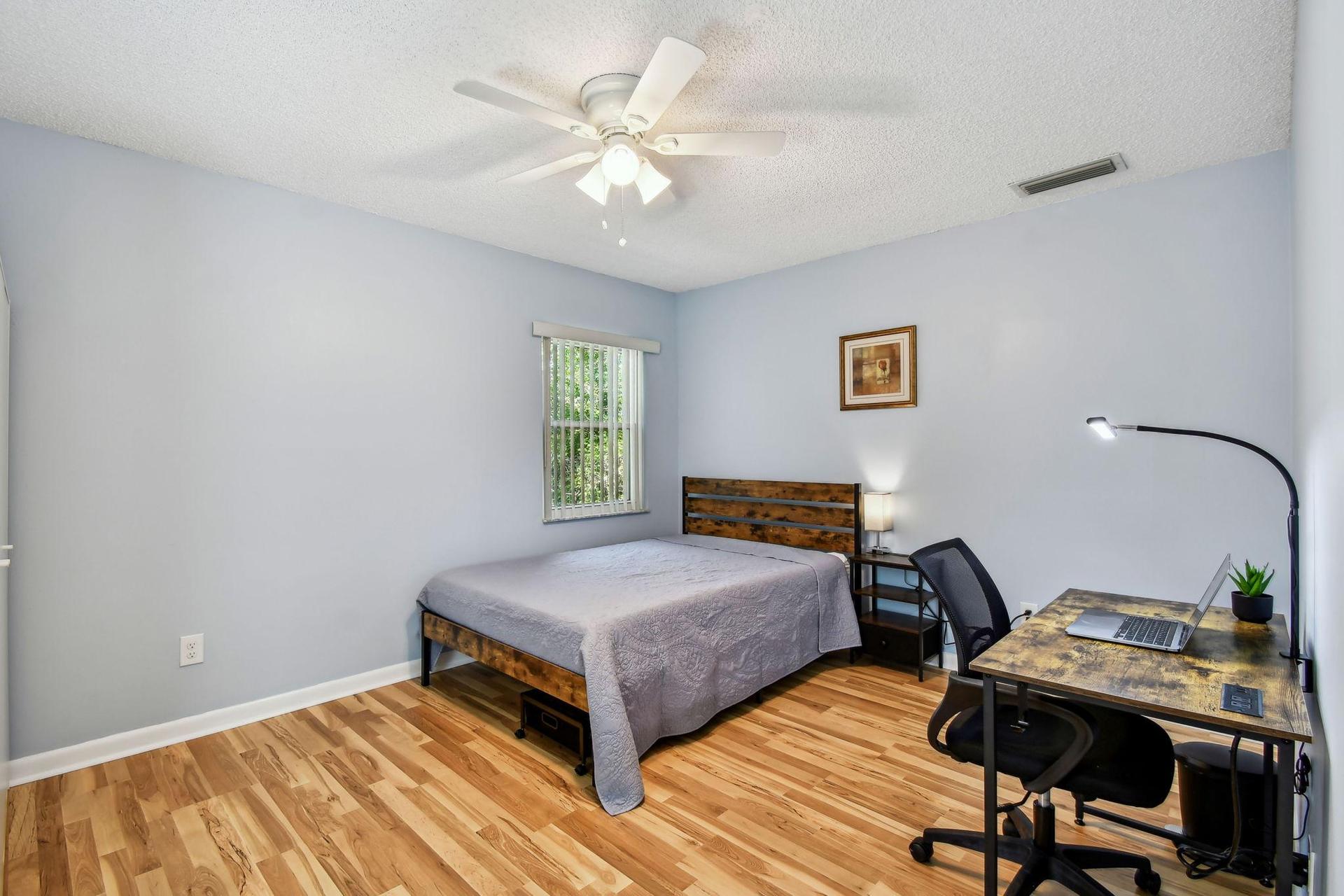 Full size cozy full size bed, with end table, light, desk, office chair and light, storage container under the bed and large