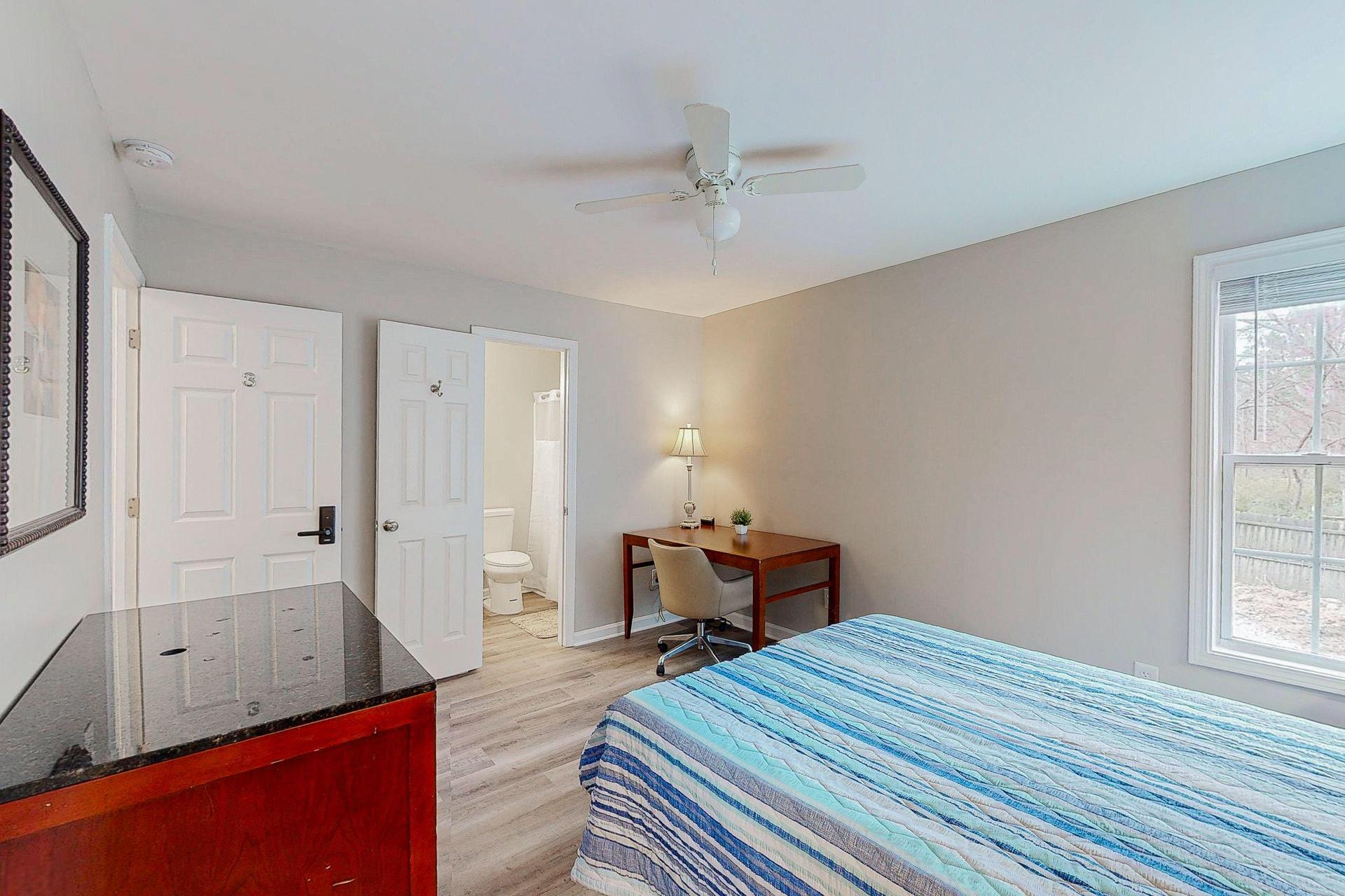 Downstairs Large Primary Bedroom 3 with desk and  private bath.