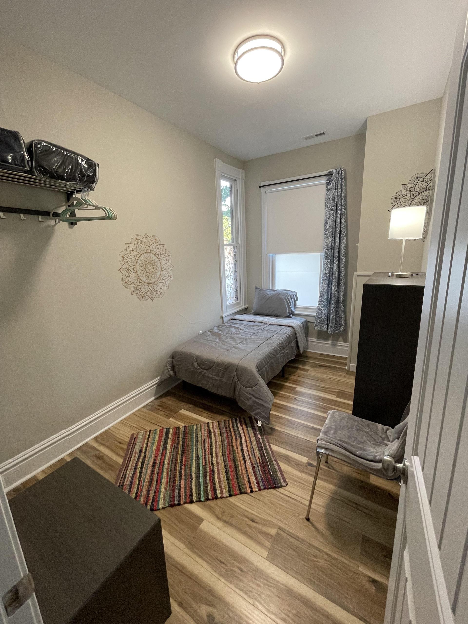 Small walk in closet at the edge of the bed. All rooms have extra shelving for storage and clothing.