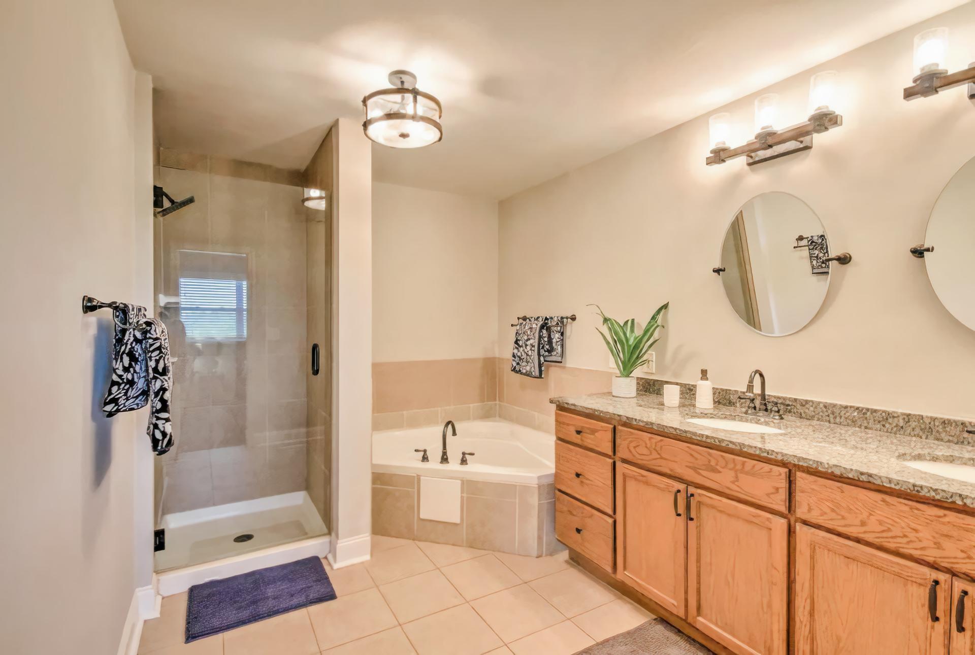 Stunning bathroom features private bath with garden bathtub, stand-alone shower, double vanity and all new plumbing fixtures!