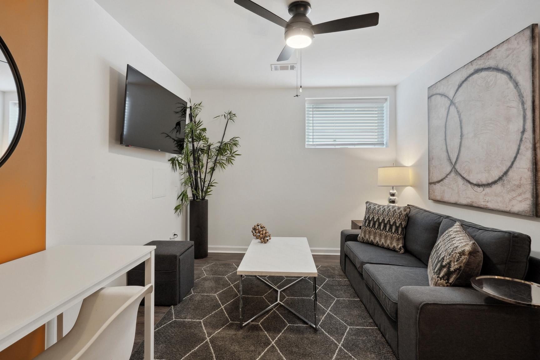 View of the Separate Sitting Area with Coffee Table, Large TV and Window