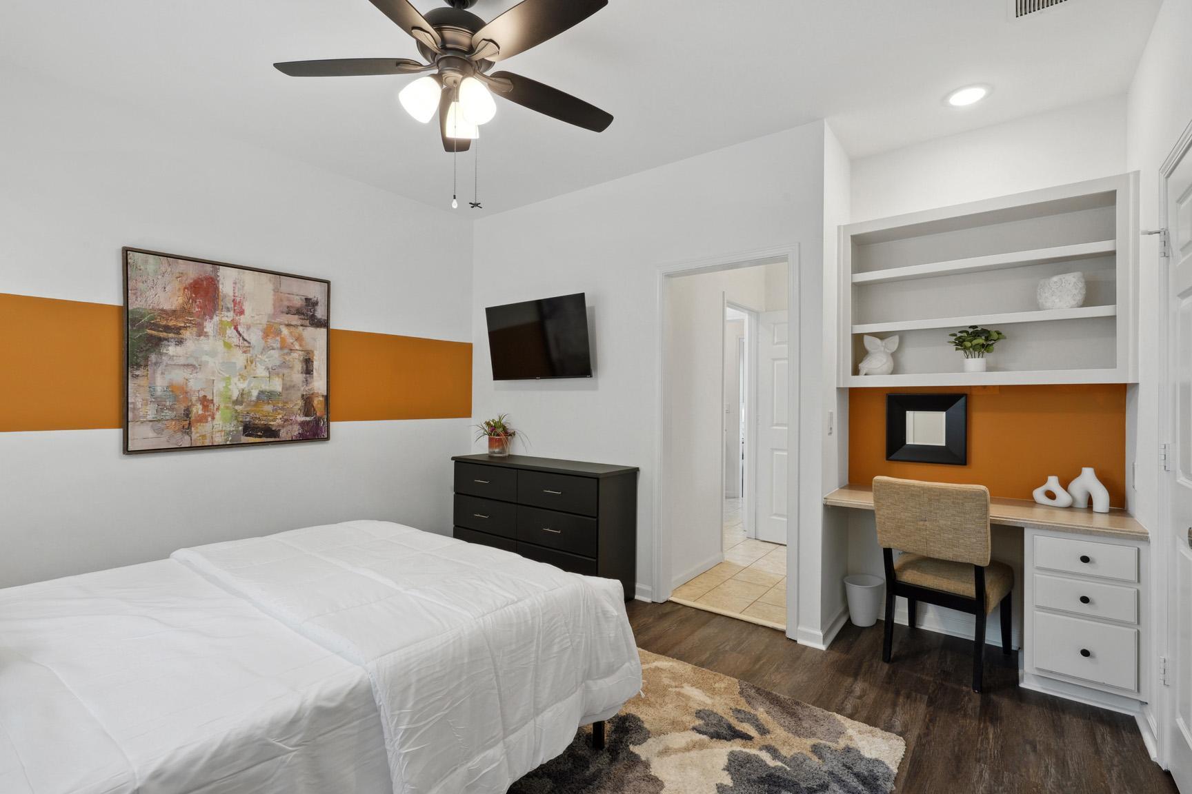 Another View of the Room with Large TV, Dresser, Spacious Work Area, and into the Private Vanity