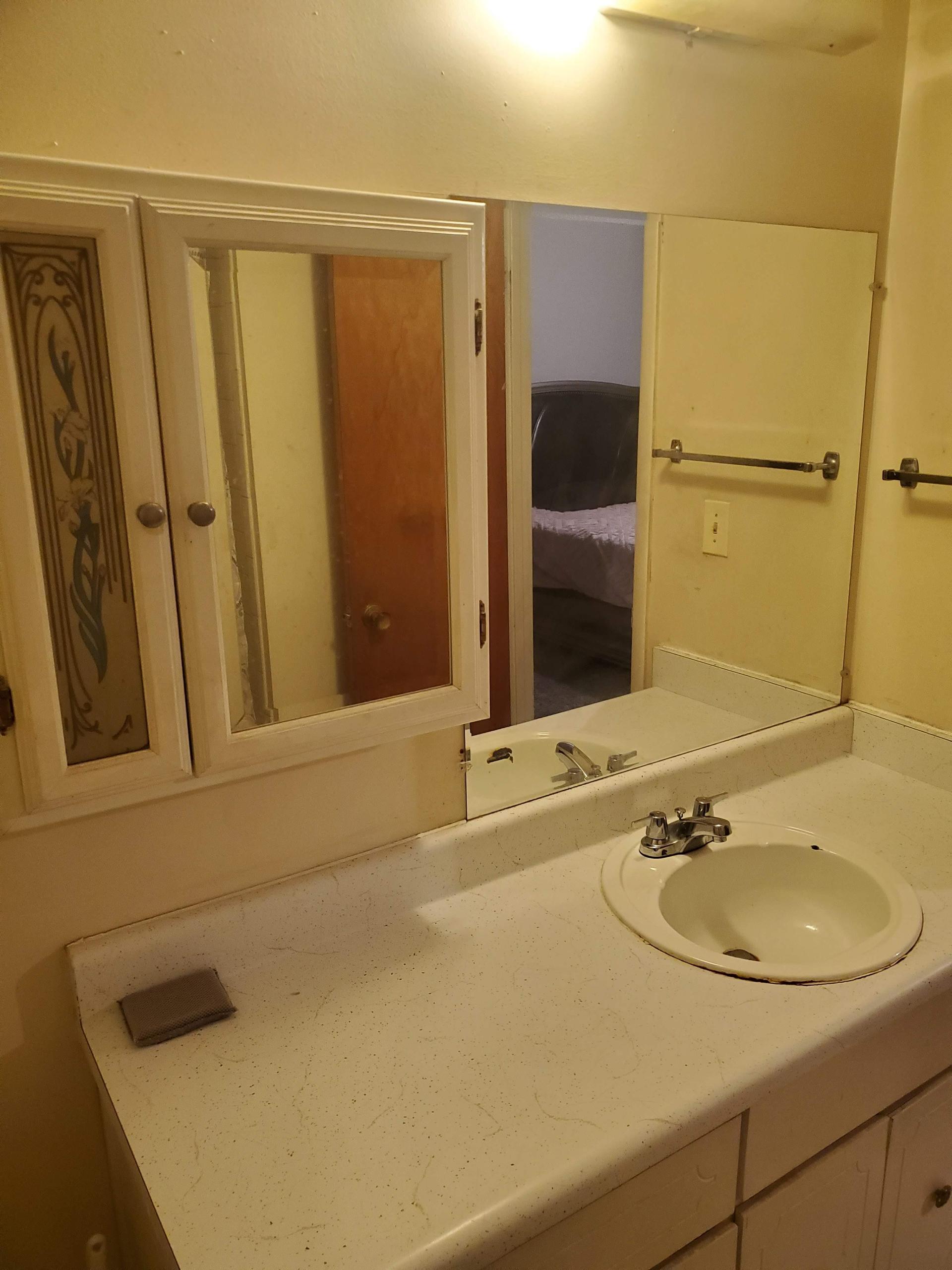 Private Bathroom with shelves, mirrors, storage.