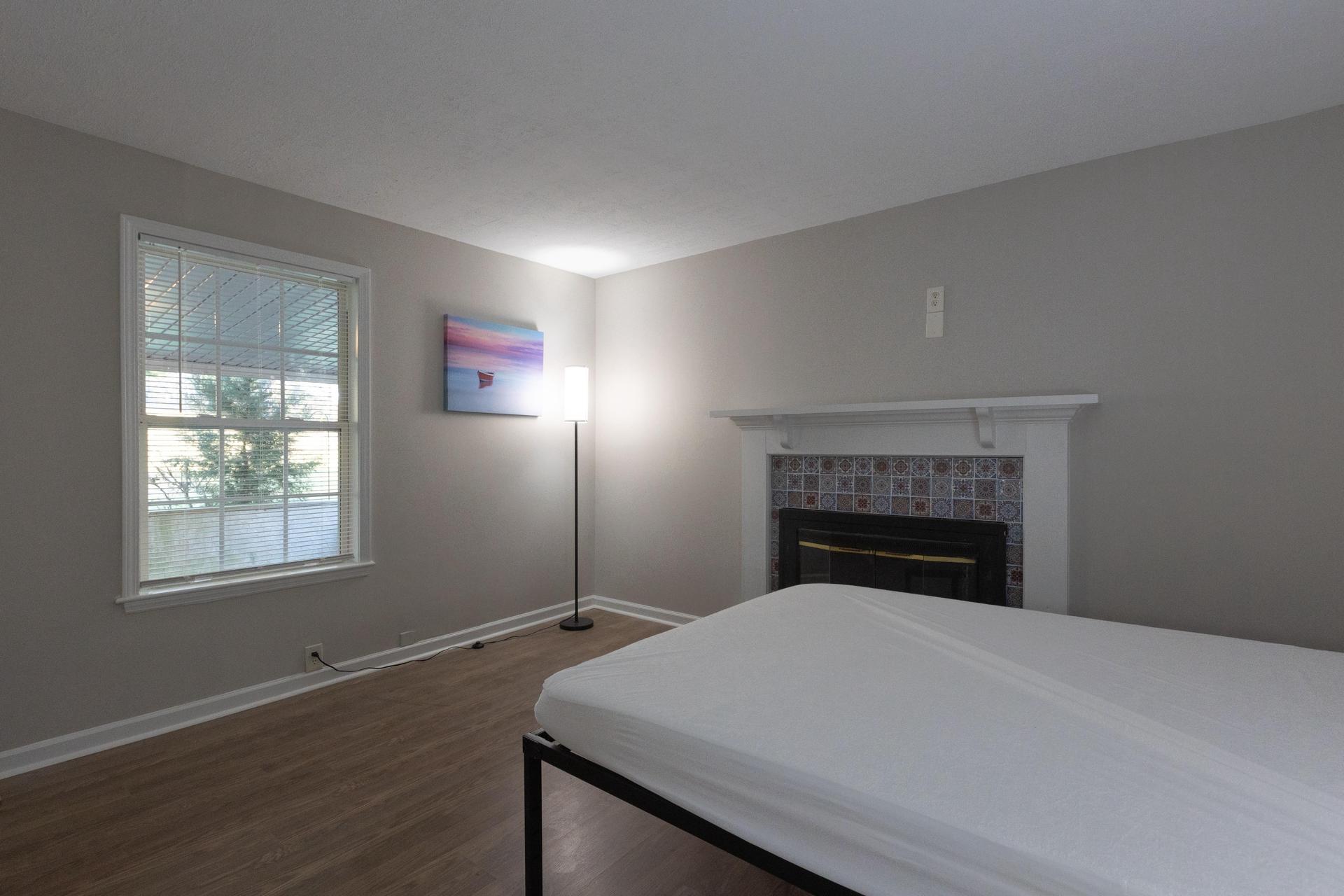 Large bedroom with a decorative fireplace (non operational)