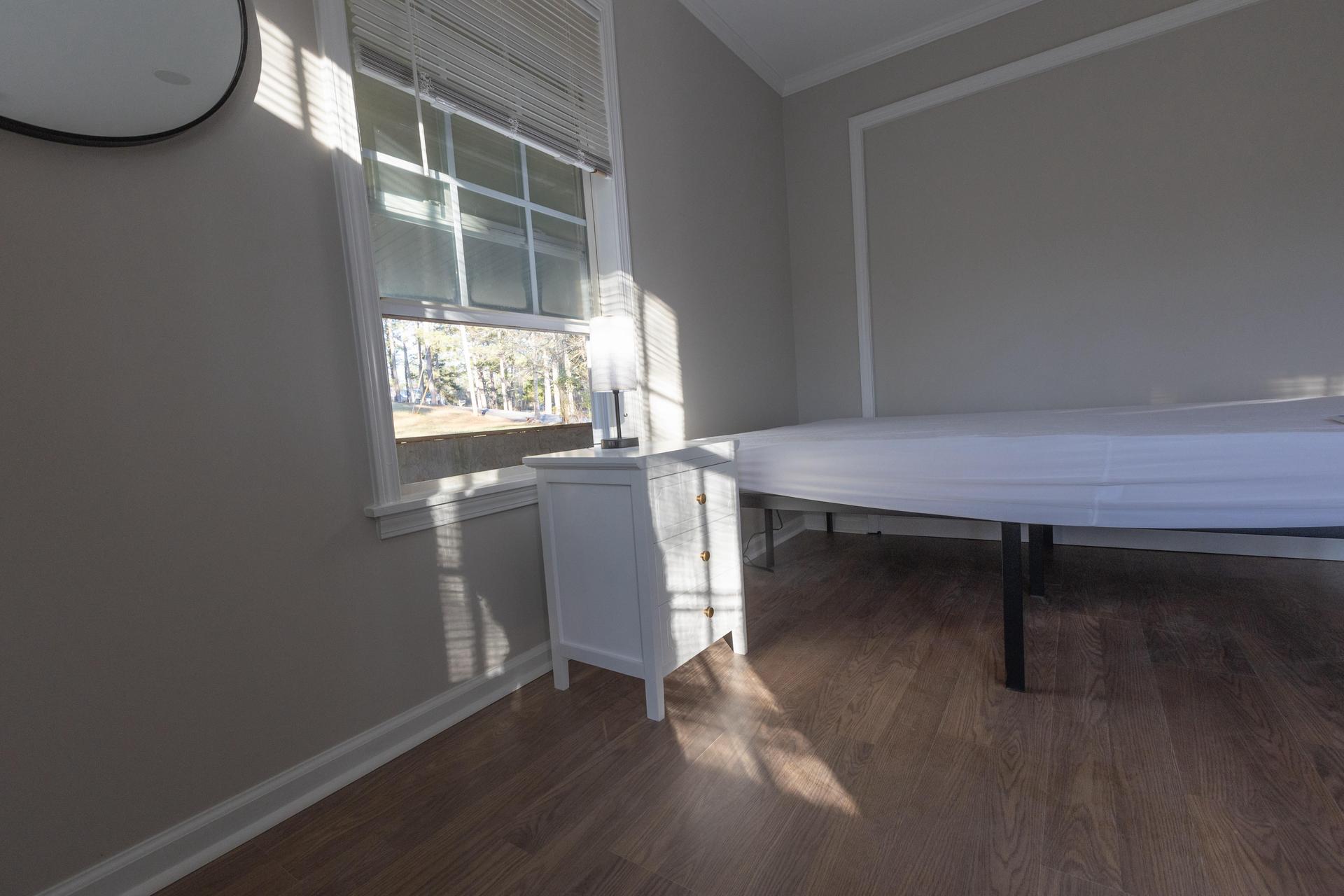 View of bed and nightstand for this room.