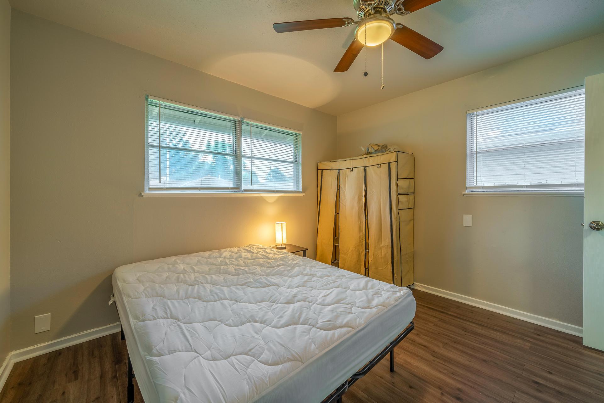 bedroom, detected: window blind, ceiling fan, bed