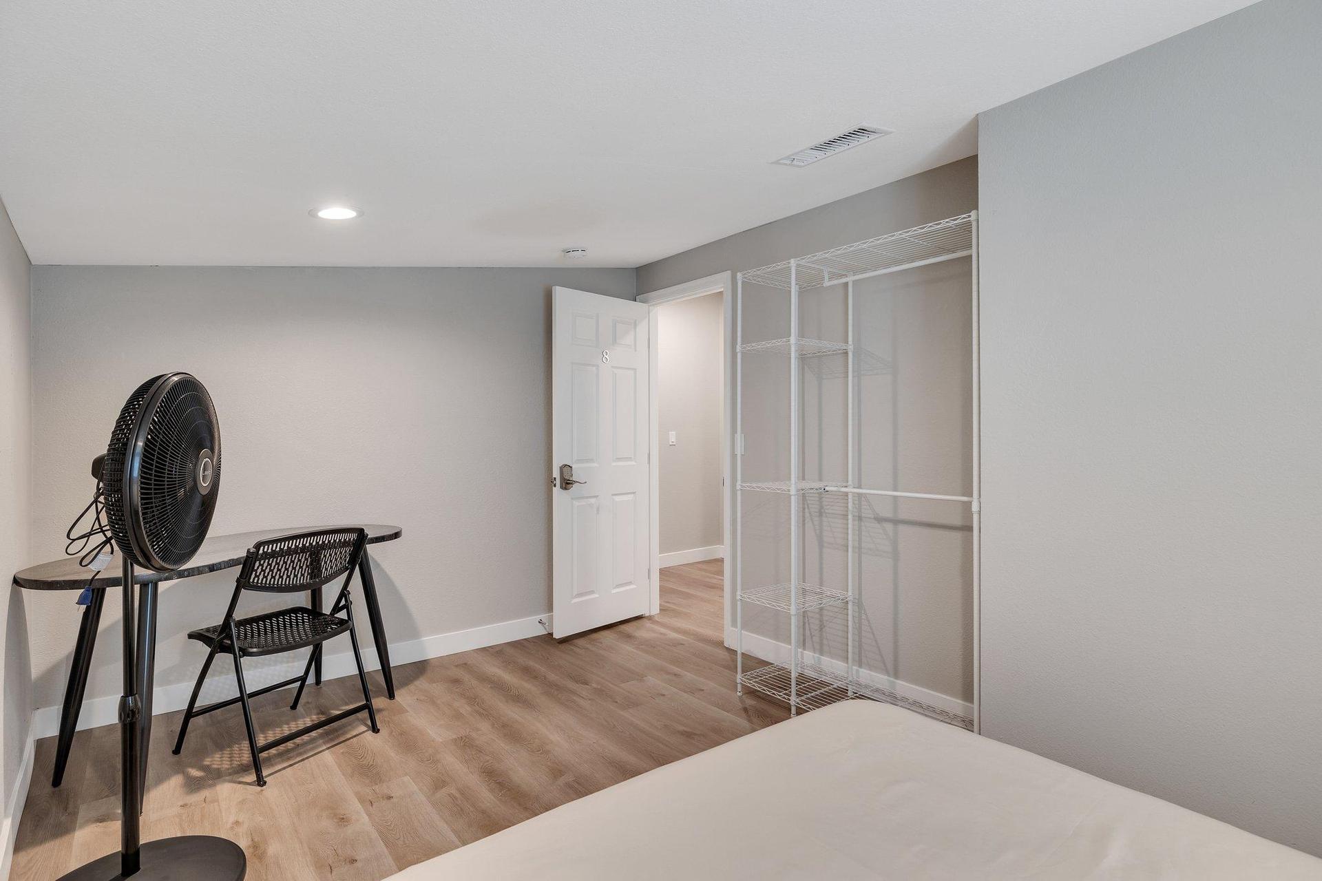 Room 8, floor fan, wardrobe, looking out to hallway