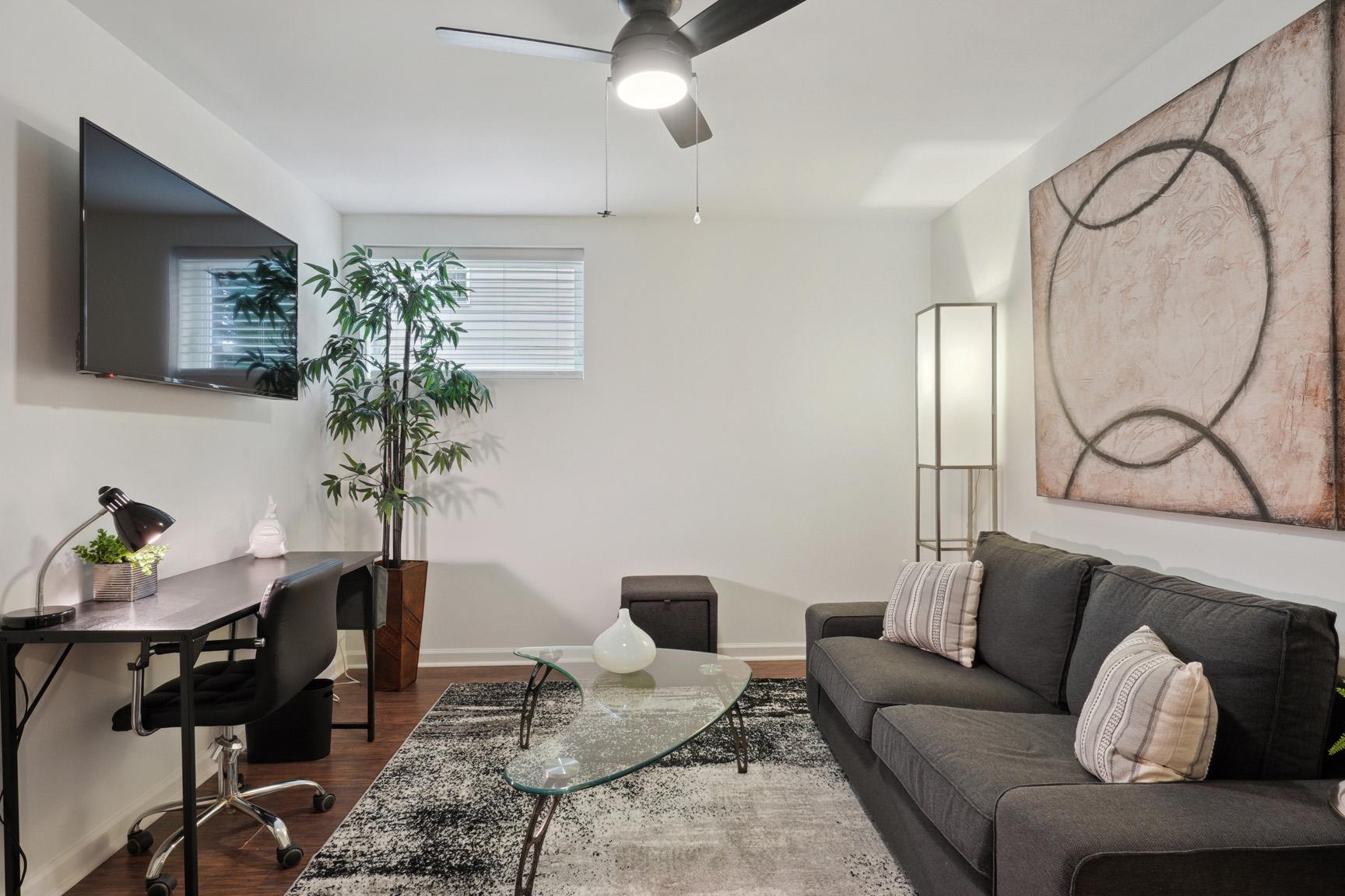 View of the Separate Sitting Area with Coffee Table, Large TV and Window