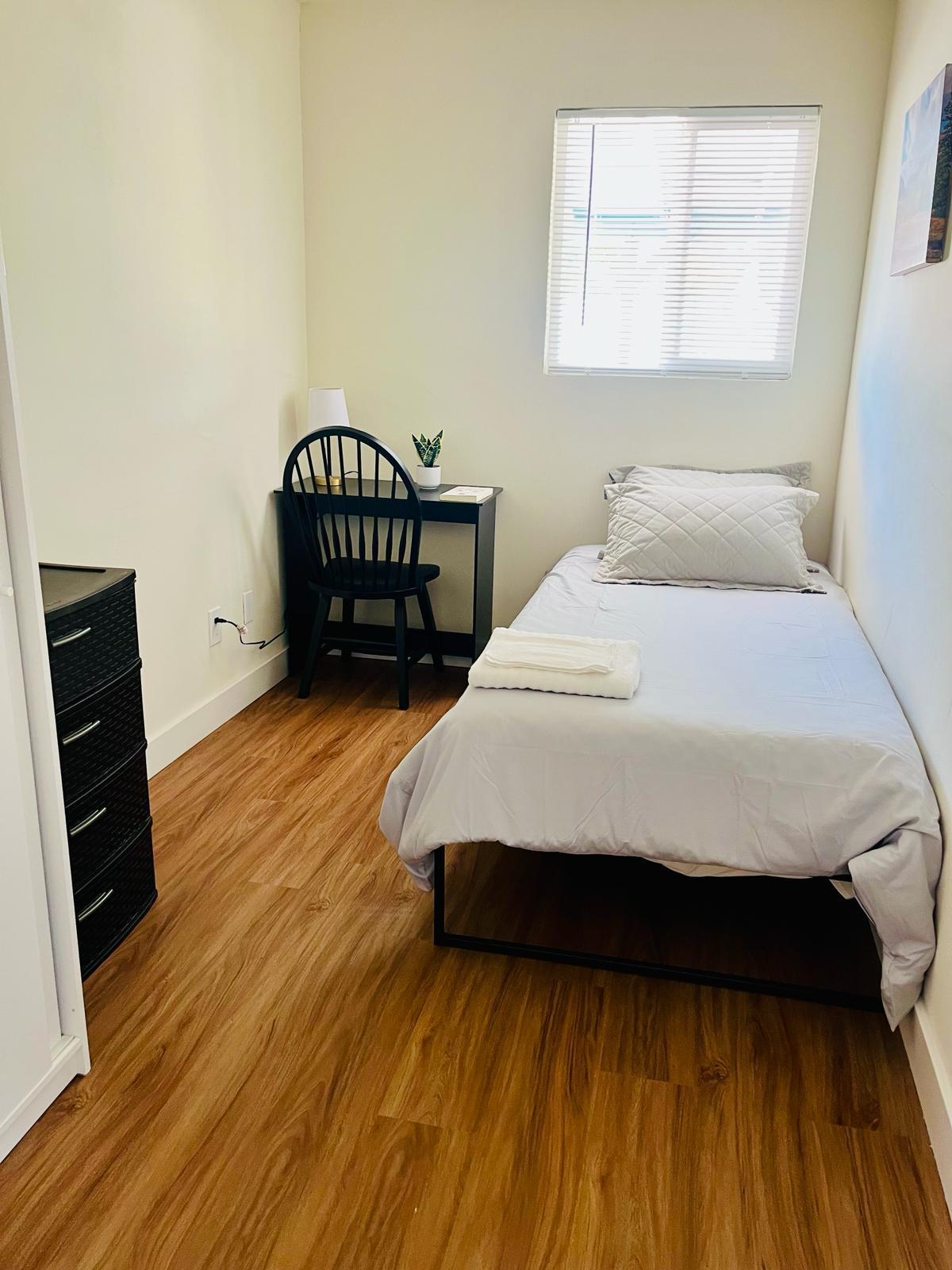 twin bed, work space, drawers and small closet