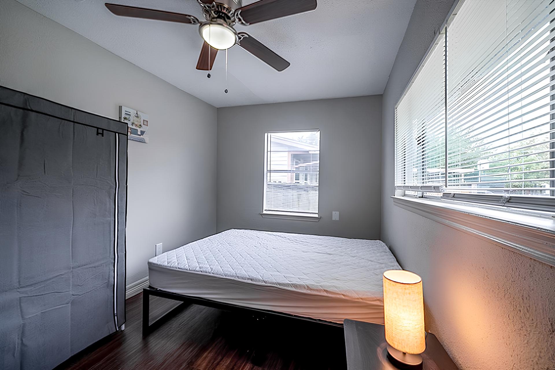 bedroom, detected: window blind, ceiling fan, bed