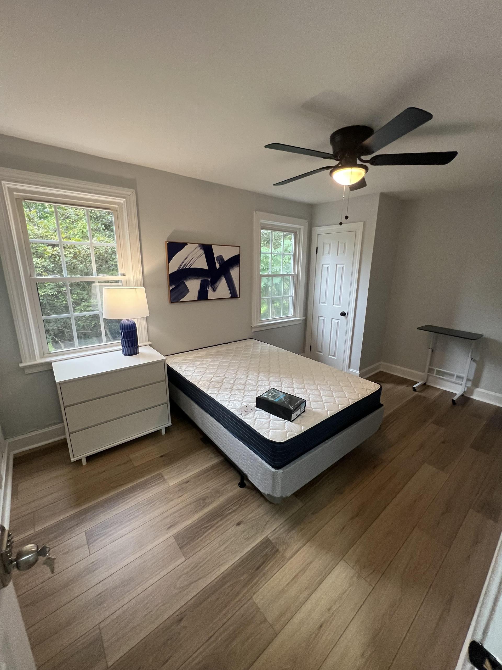 Upstairs bedroom next to bathroom with closet moveable TV tray and extra storage in the nightstand! Views back