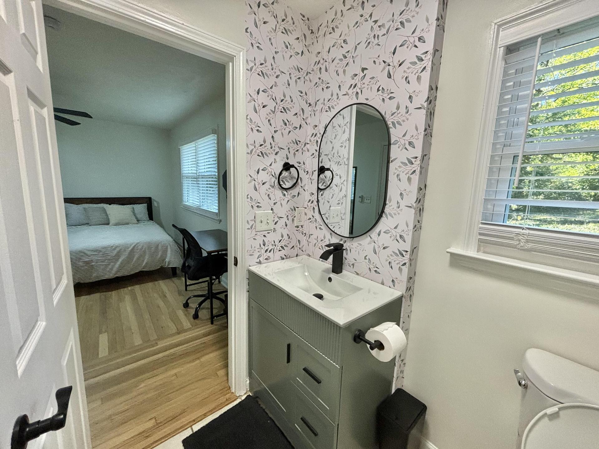 Private master bathroom with vanity storage and a shower/tub combo