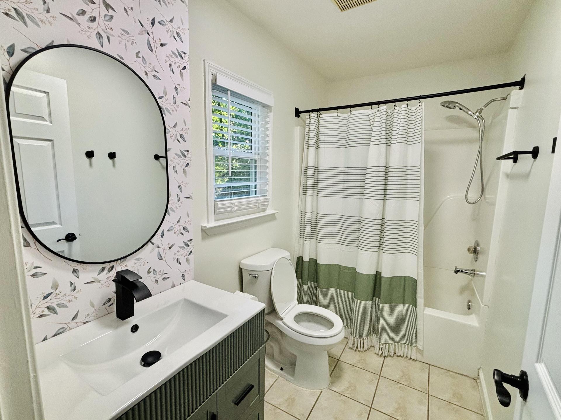 Private master bathroom with vanity storage and a shower/tub combo