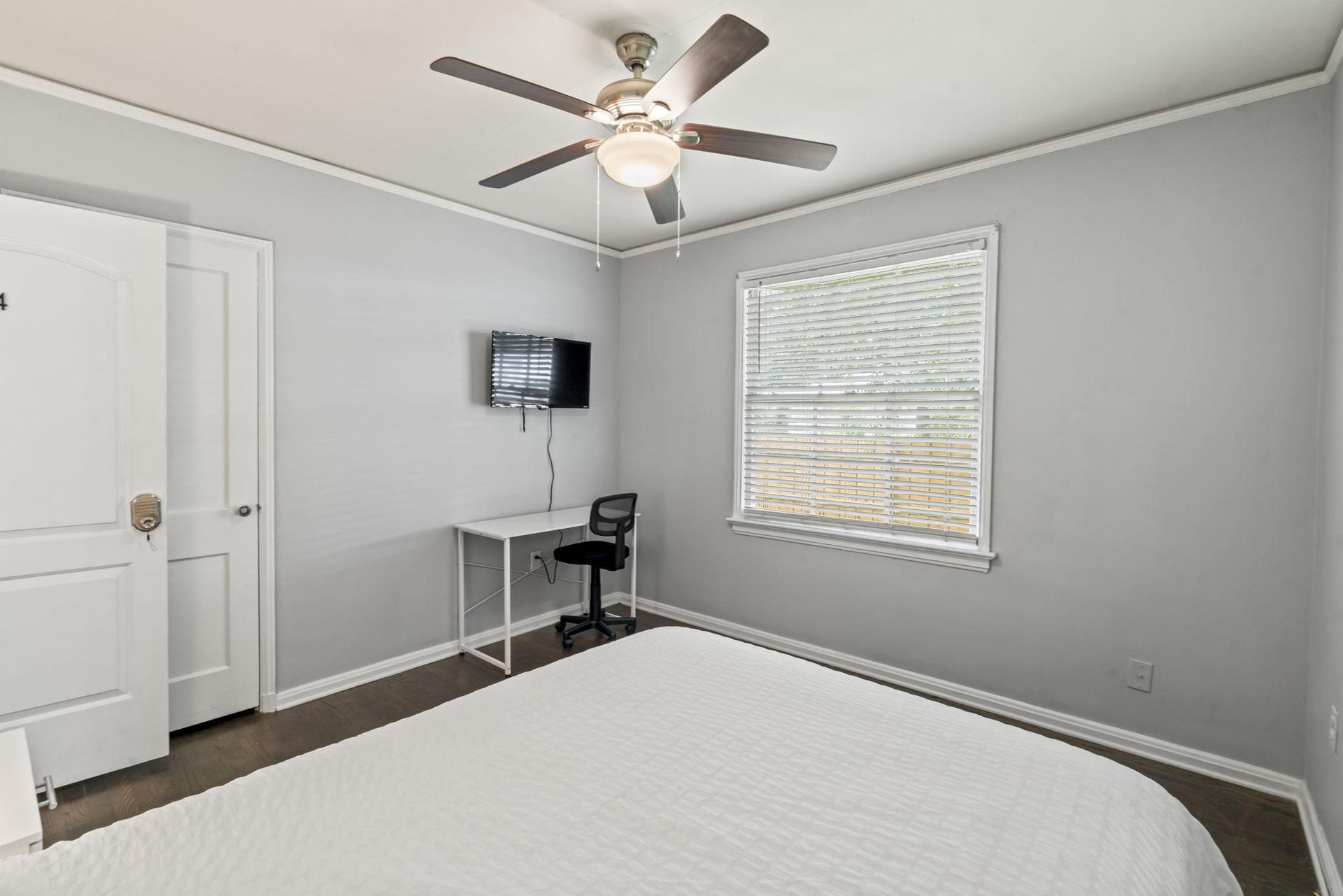 This room includes TV, workspace and ceiling fan