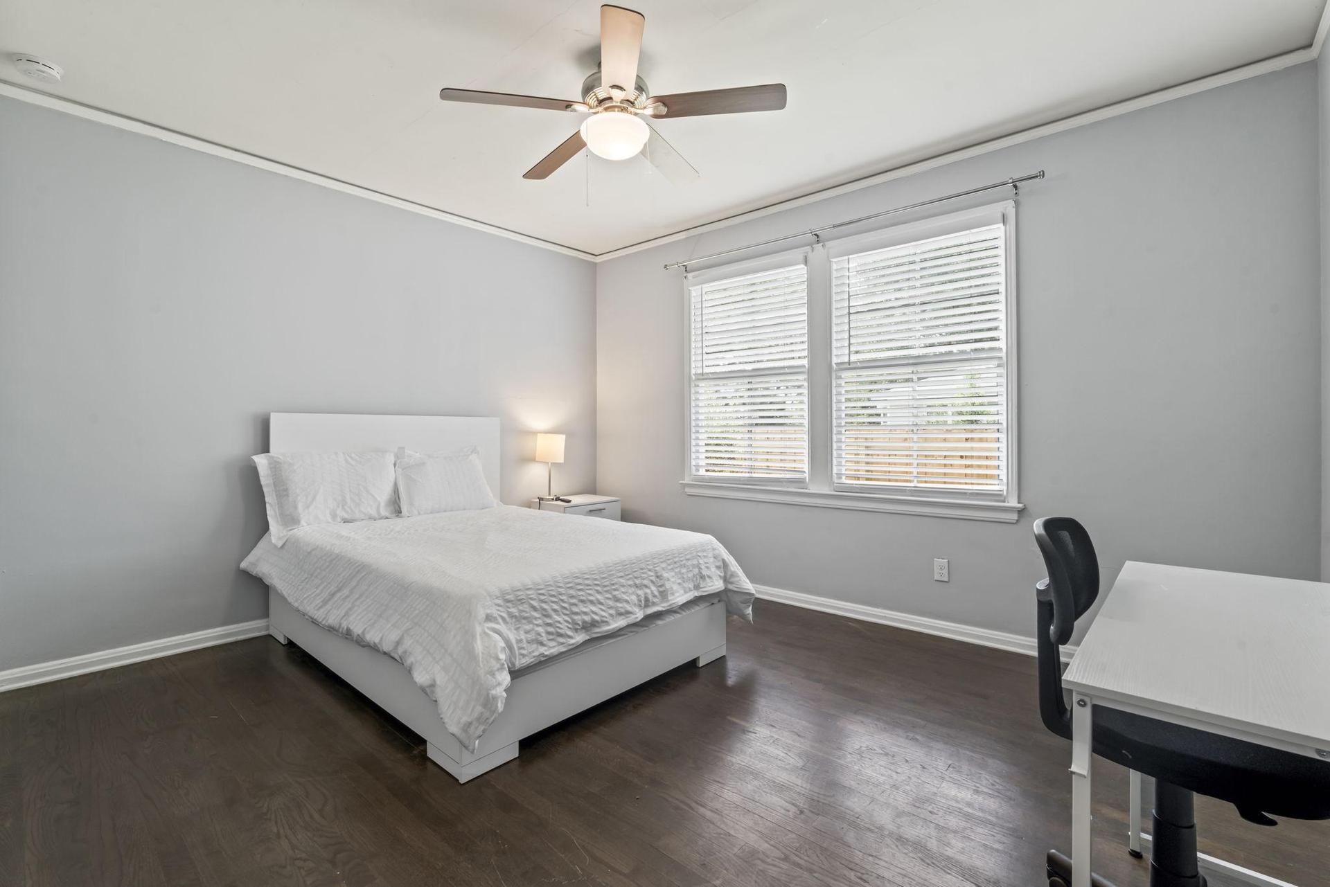 This room includes TV, workspace and ceiling fan