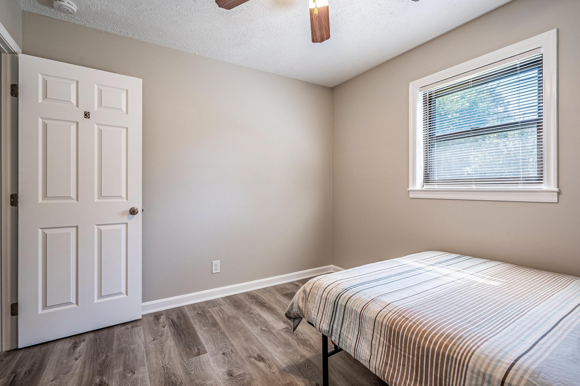 bedroom, detected: window blind, bed, ceiling fan