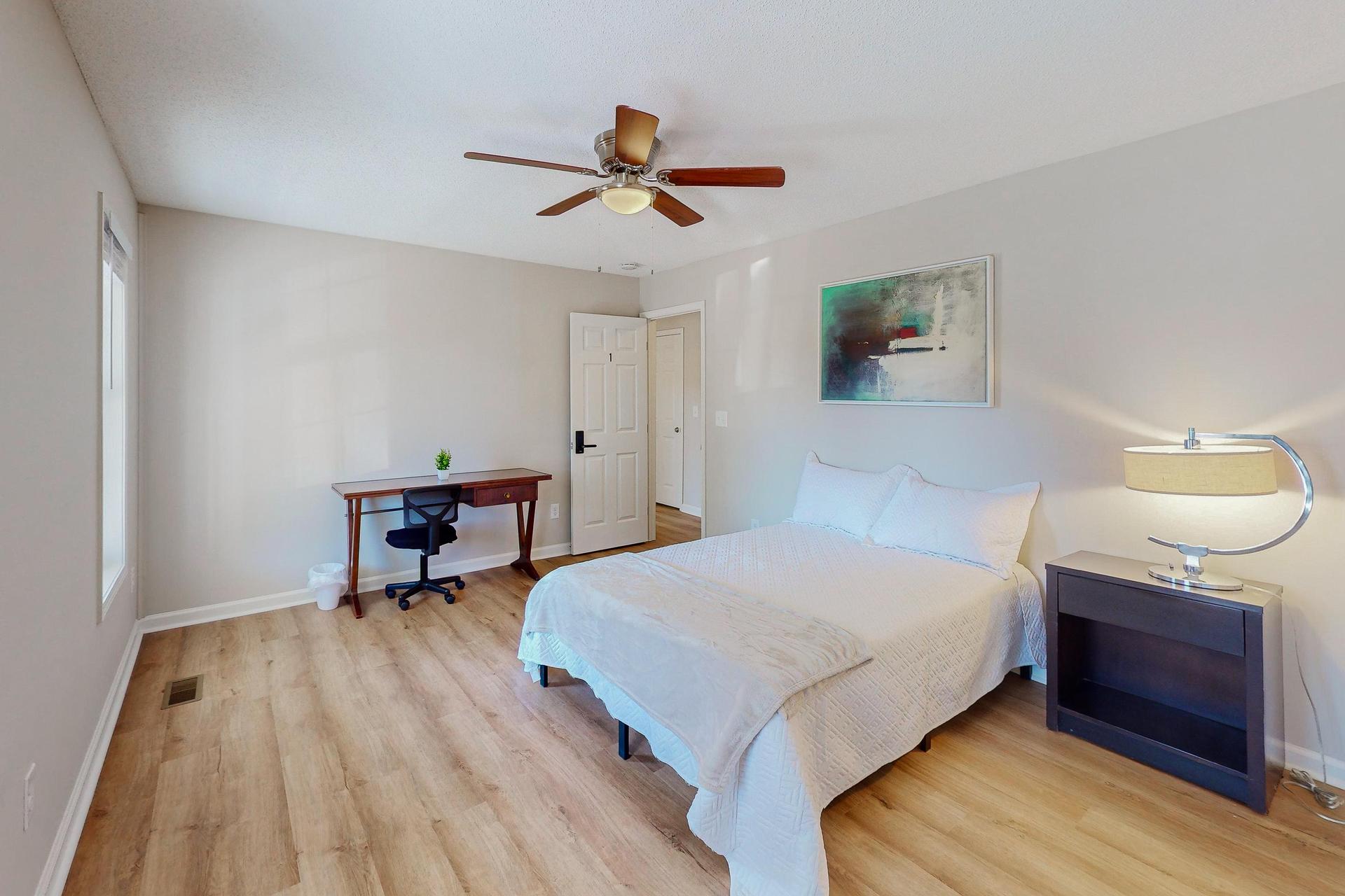 Private bedroom with Full size bed, nightstand, desk, ceiling fan and closet.