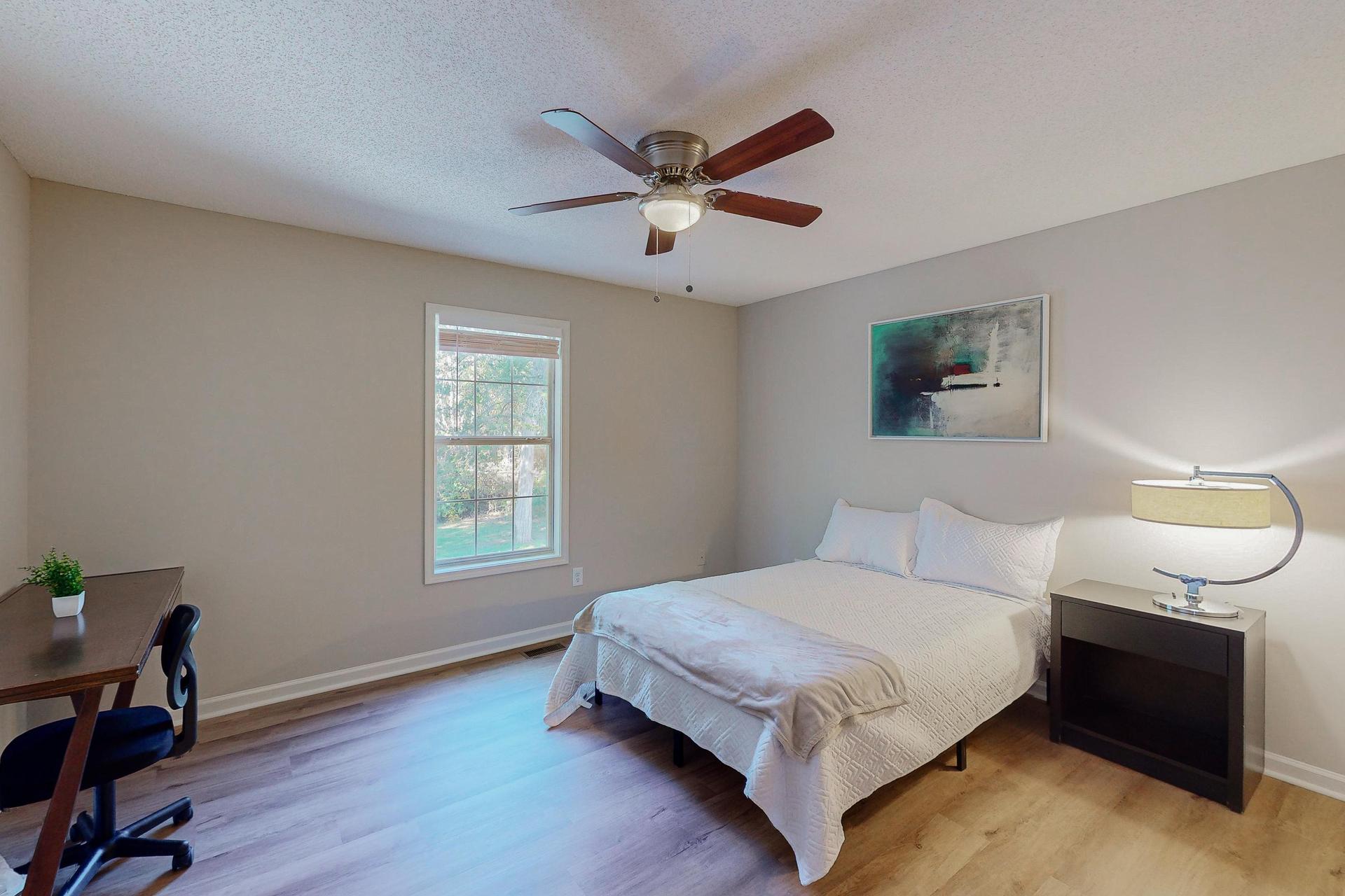 Private bedroom with Full size bed, nightstand, desk, ceiling fan and closet.