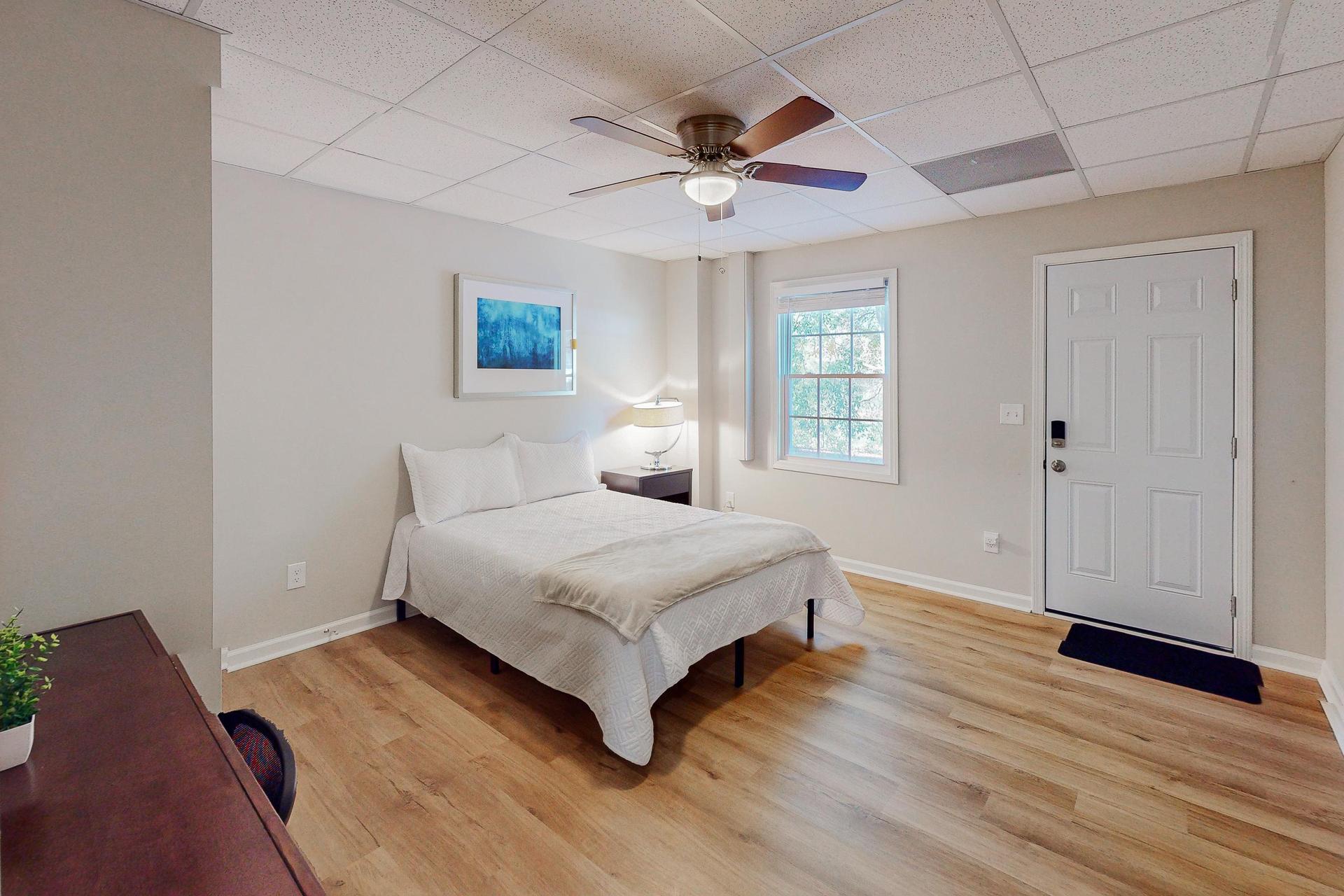 Bedroom complete with Private Access, full size bed, nightstand, desk, ceiling fan and closet.