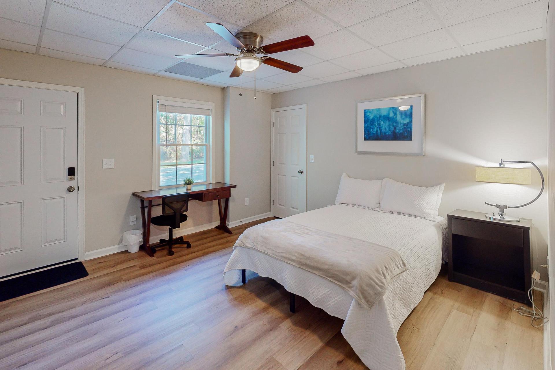 Bedroom complete with Private Access, full size bed, nightstand, desk, ceiling fan and closet.