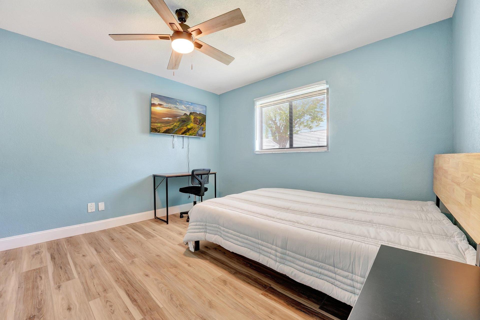 Bedroom with desk, tv and closet