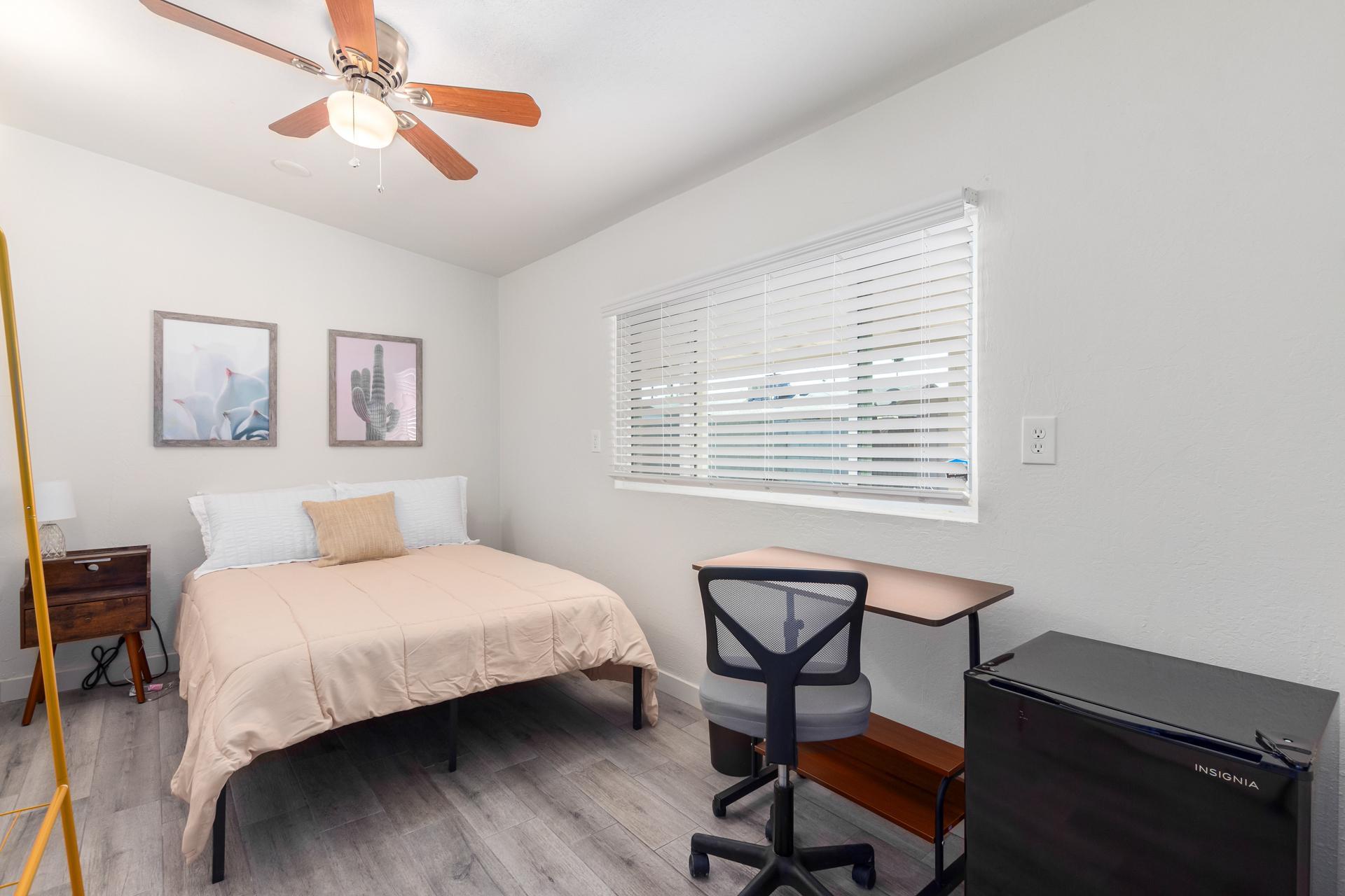 Room 7- ceiling fan, desk chair and mini fridge