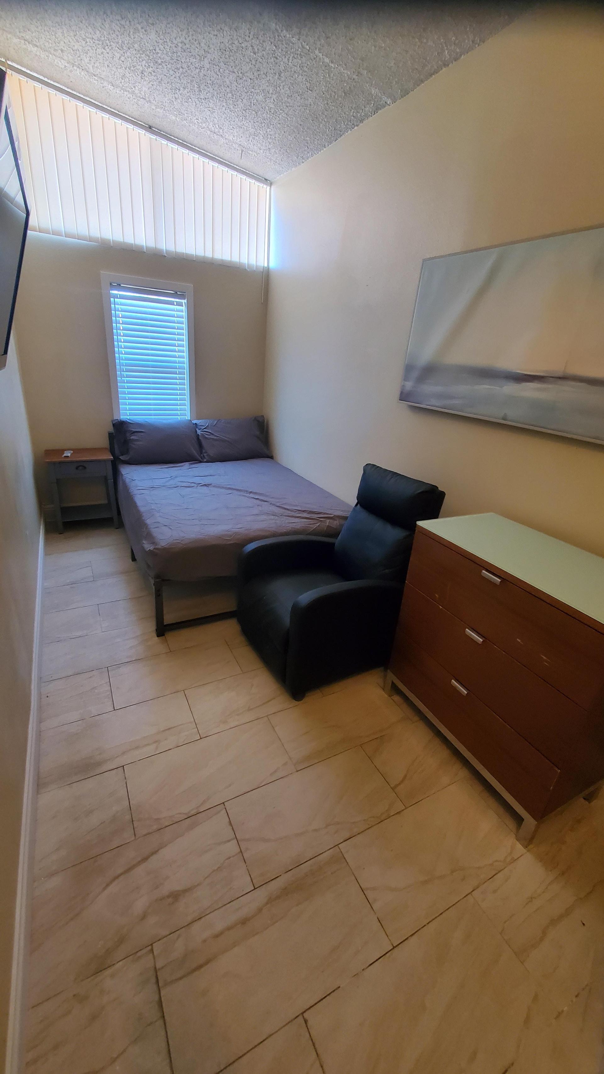 Long room with closet and wall mounted TV