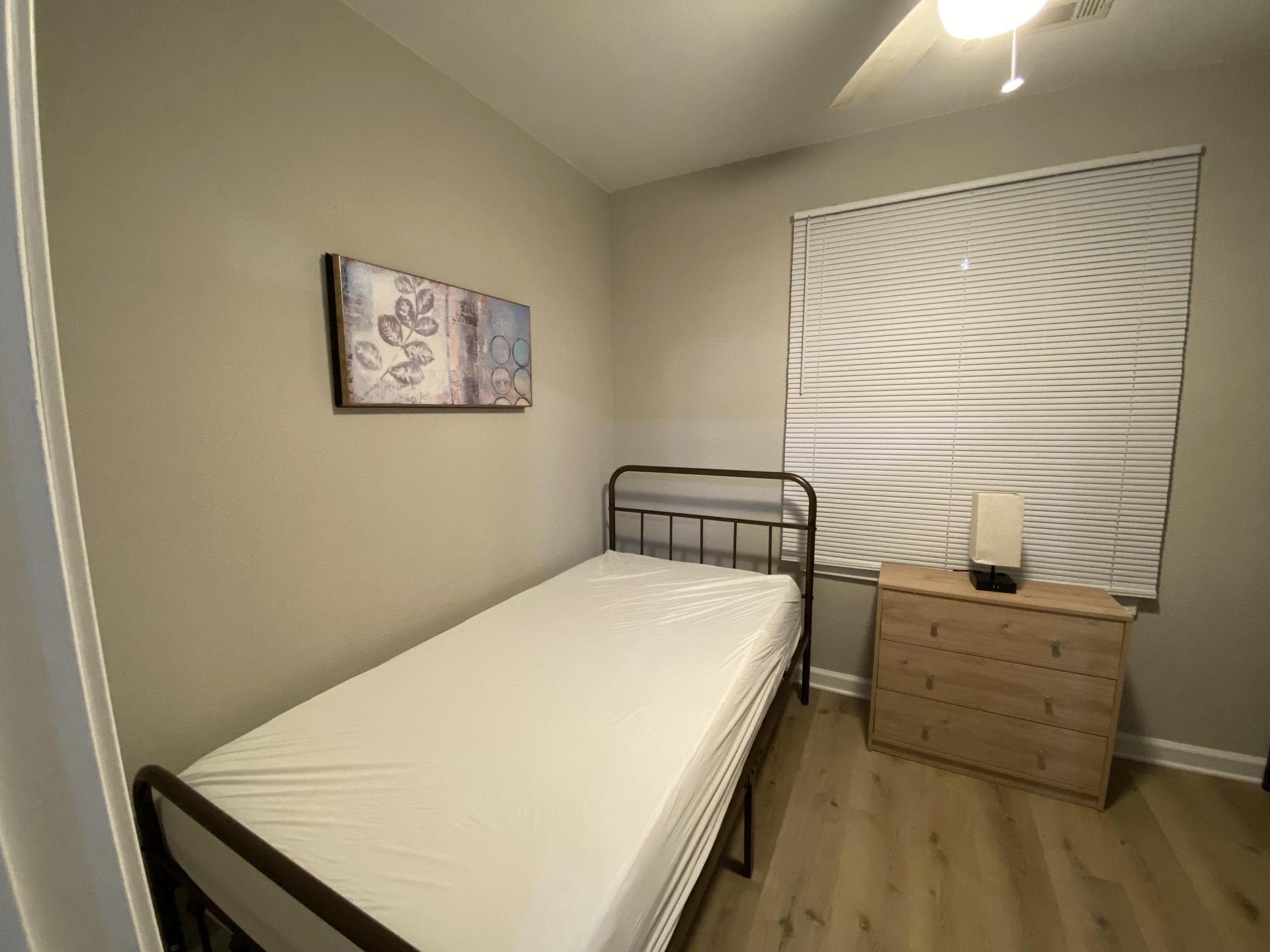 Cozy Twin Bed with night table and touch lamp