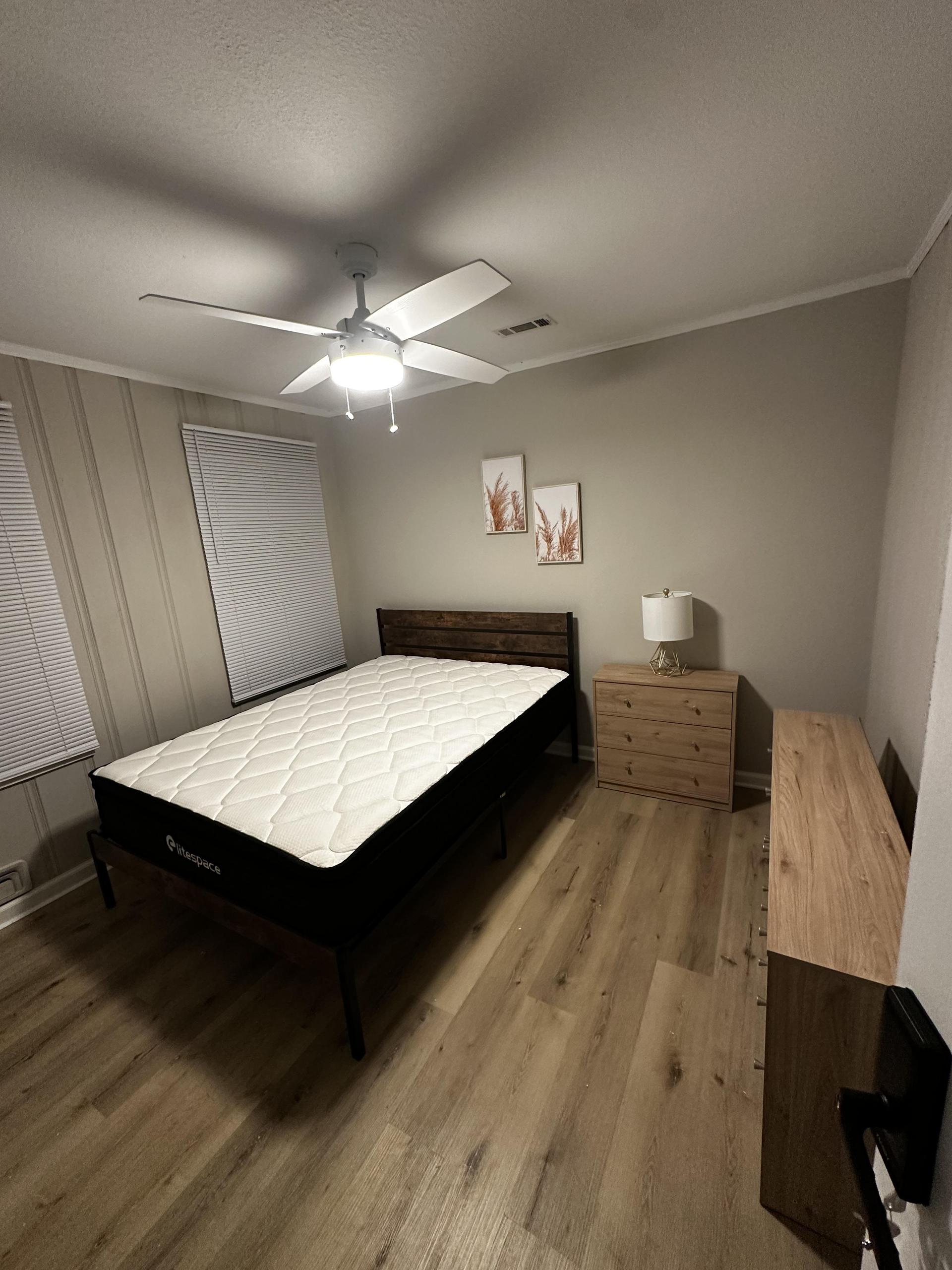 Queen Bed with nightstand and touch lamp.